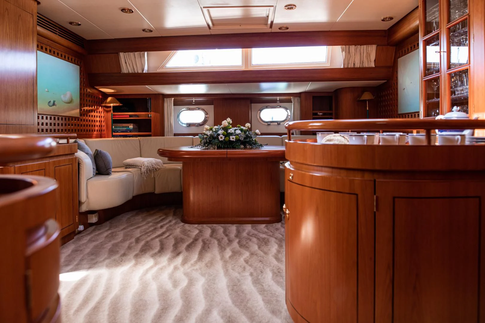 a large room with a couch and a table aboard SCARENA Yacht for Charter