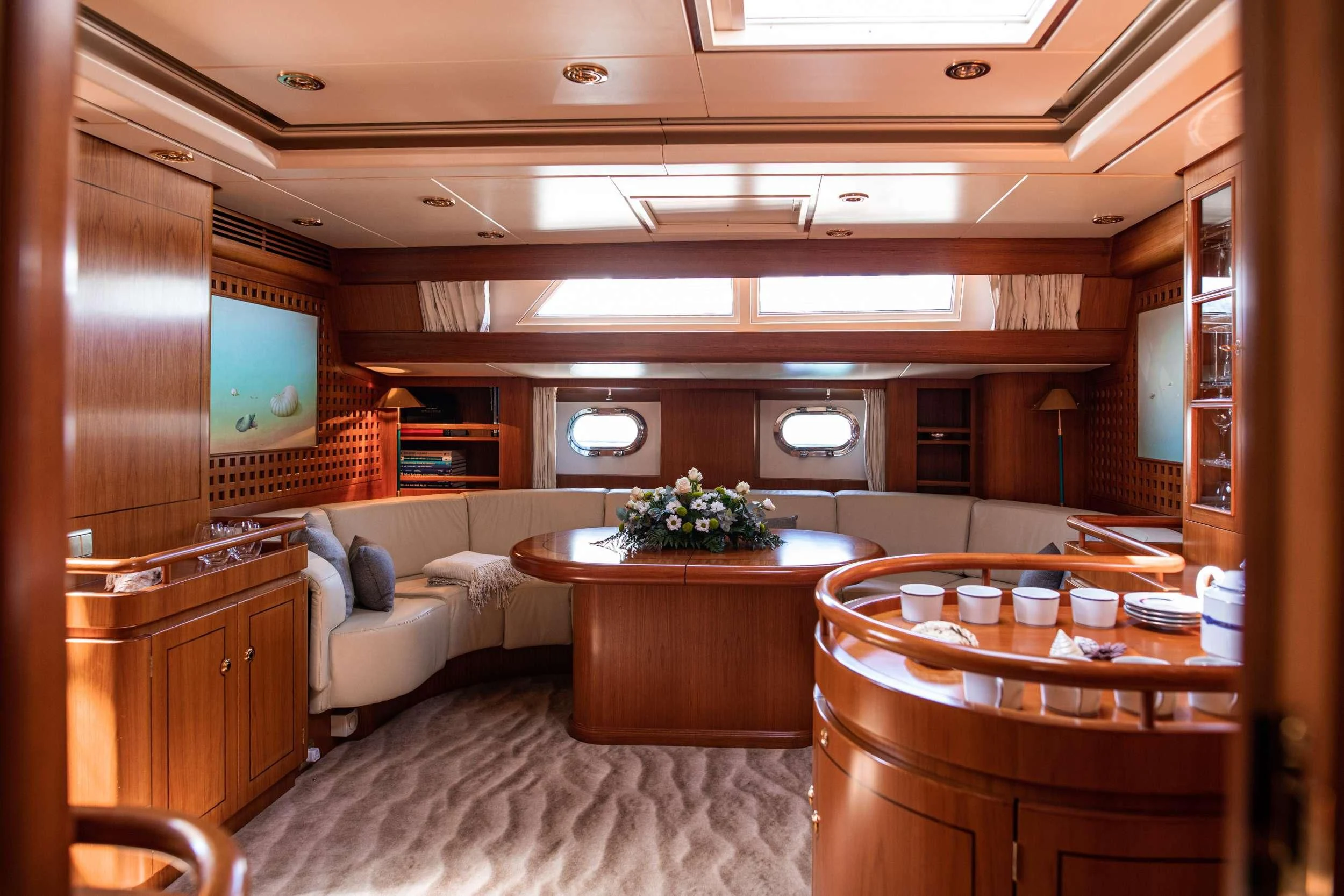 a living room with a table and chairs aboard SCARENA Yacht for Charter