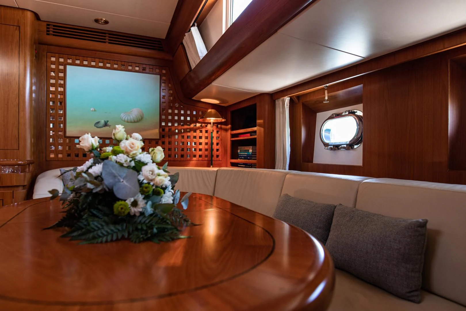 a living room with a couch and a table aboard SCARENA Yacht for Charter