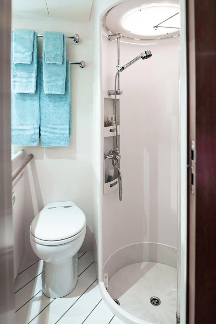 a bathroom with a toilet and bathtub aboard SCARENA Yacht for Charter
