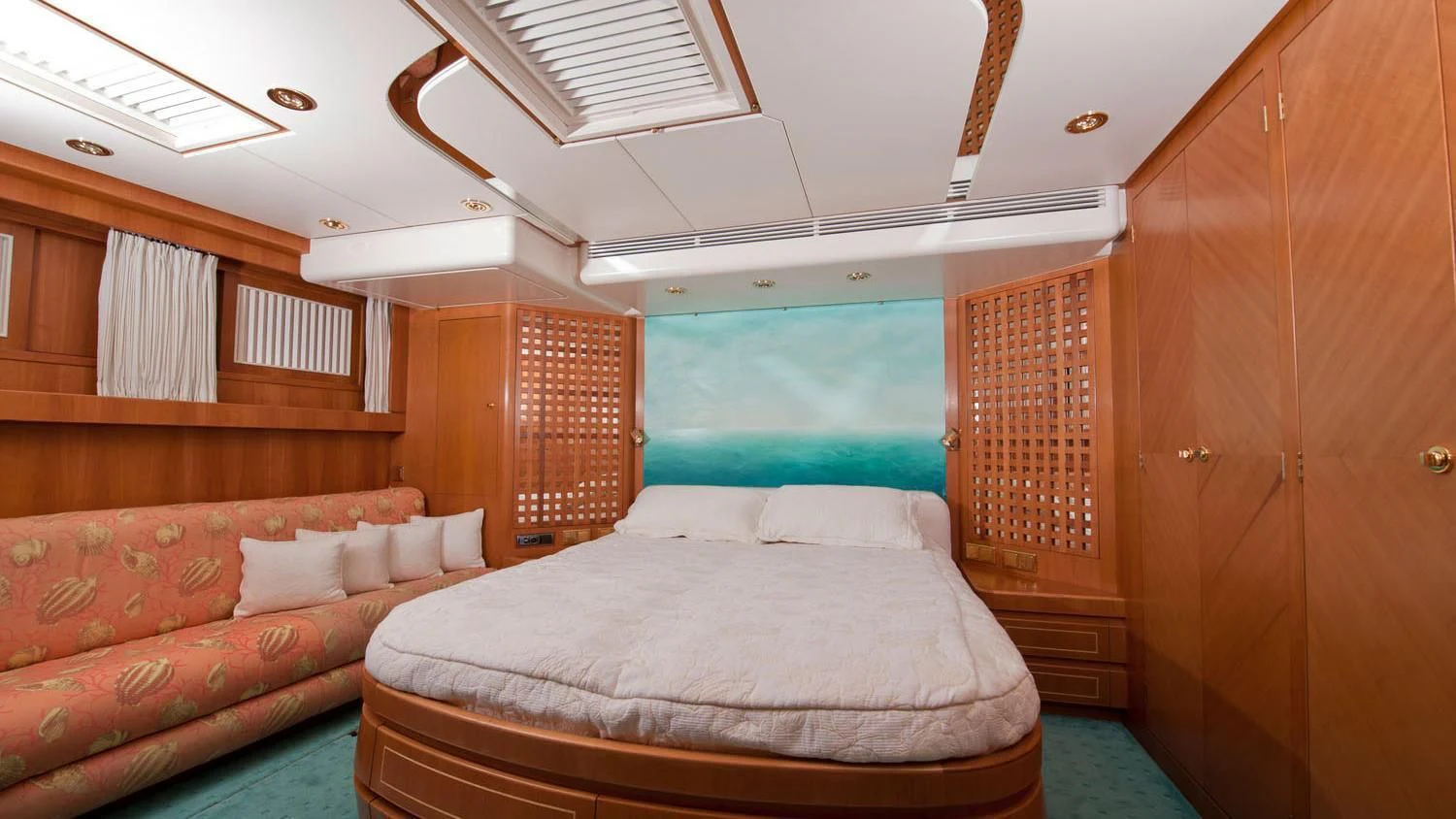 a room with a bed and a couch aboard SCARENA Yacht for Charter