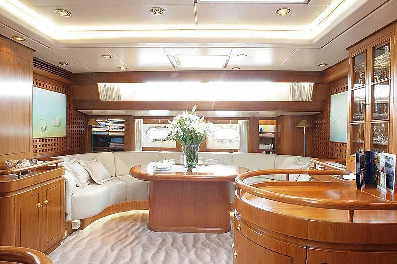 a room with a table and couch aboard SCARENA Yacht for Charter