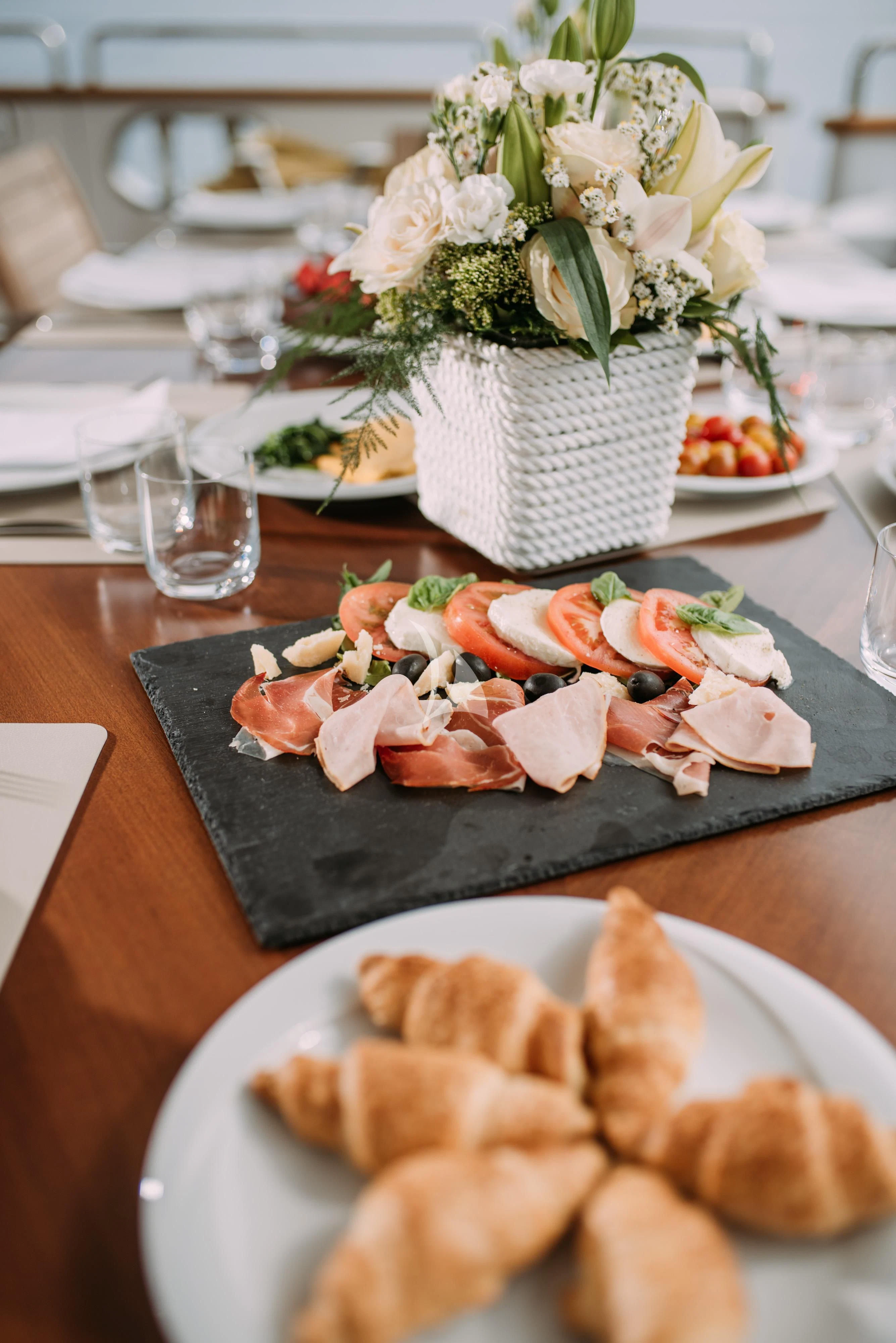a table with plates of food aboard ARTEMY Yacht for Sale