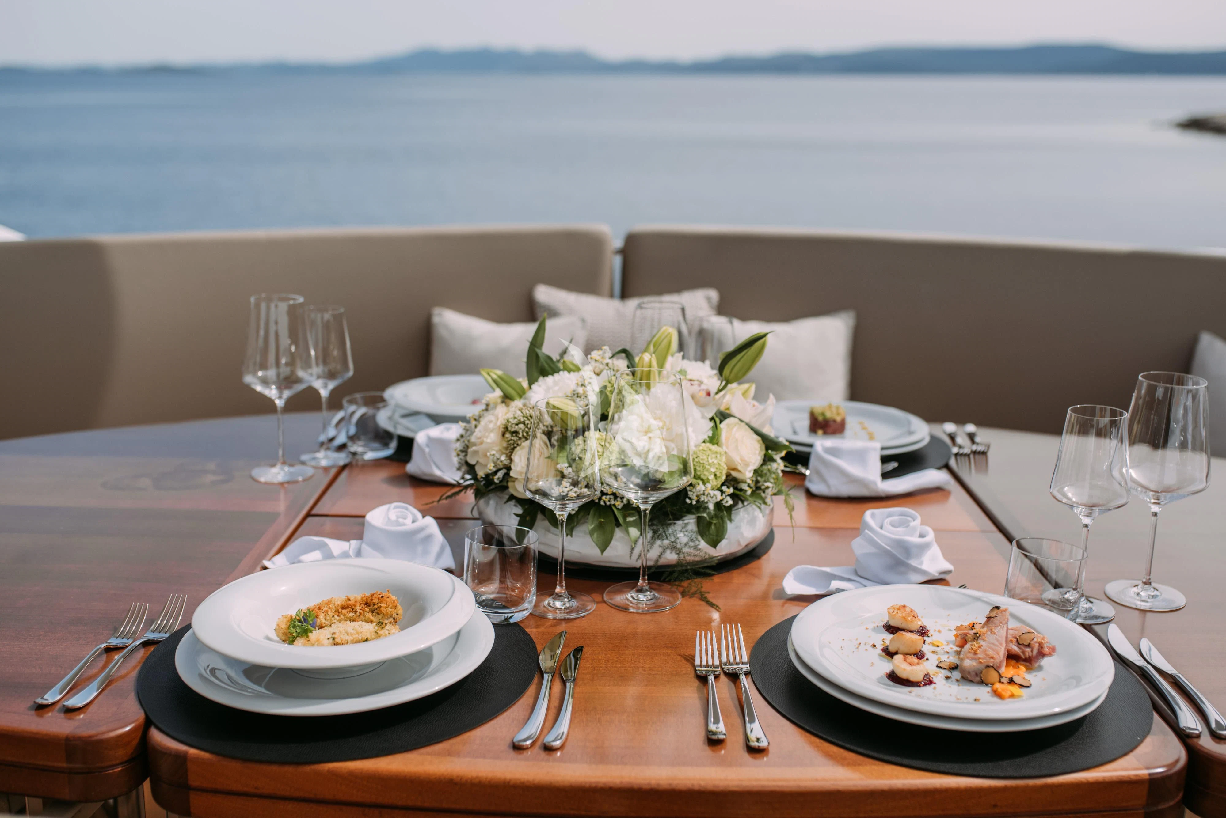 a table with plates and food on it aboard ARTEMY Yacht for Sale