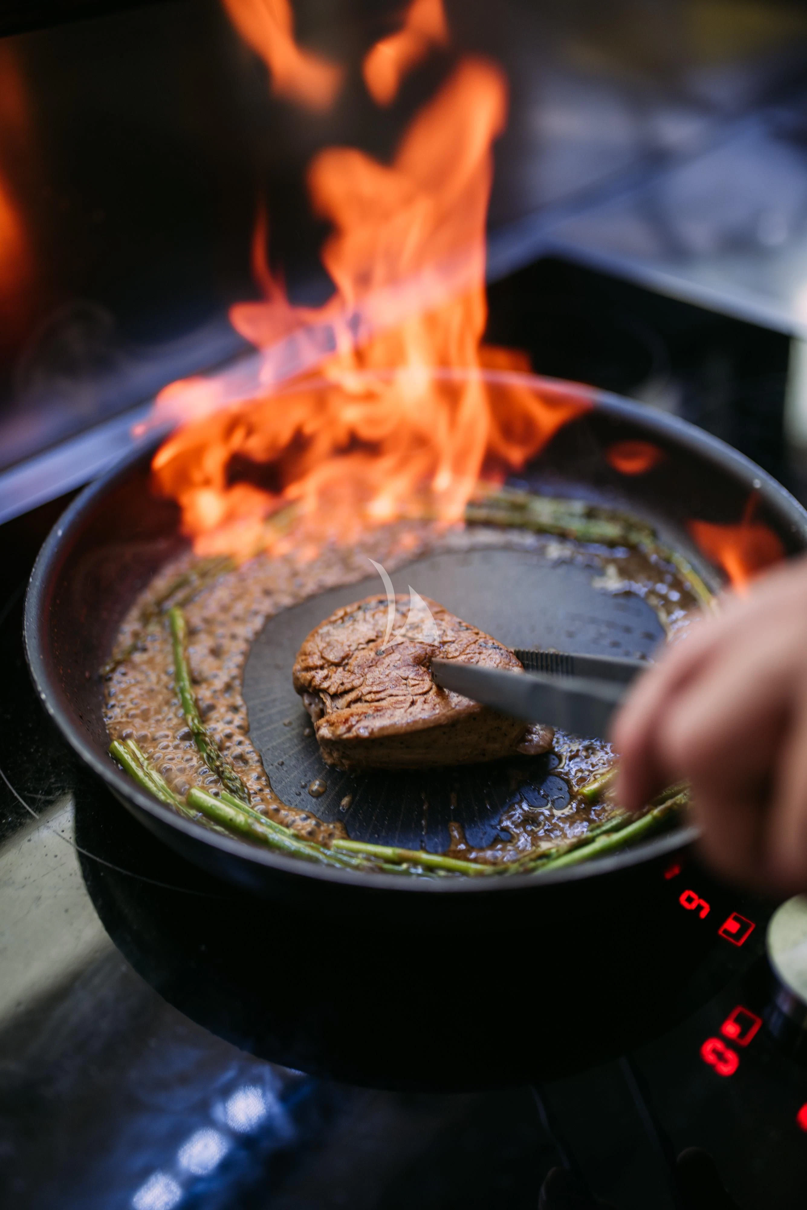 a person holding a fork over a plate of food aboard ARTEMY Yacht for Sale