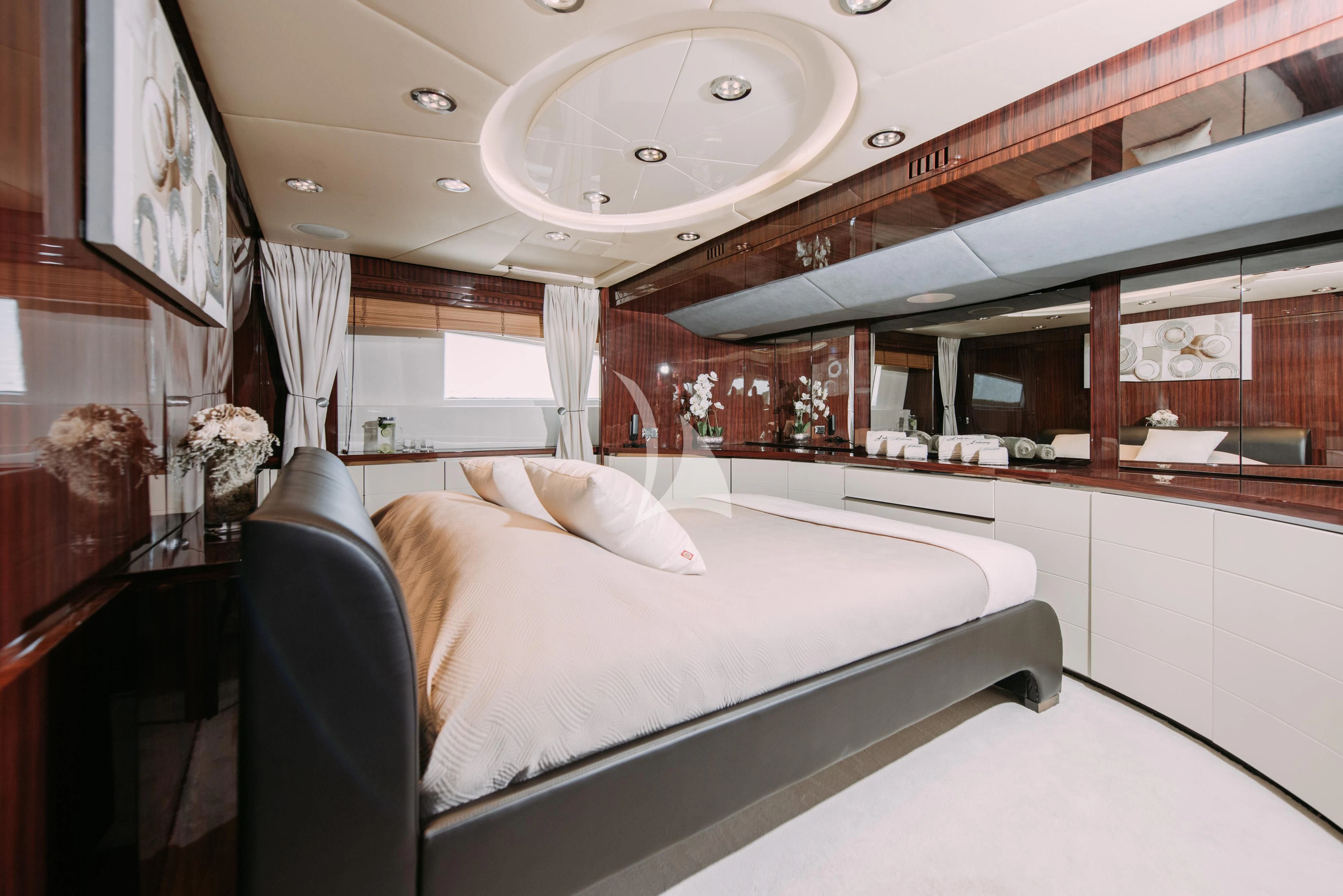 a room with a bed and a large mirror aboard ARTEMY Yacht for Sale