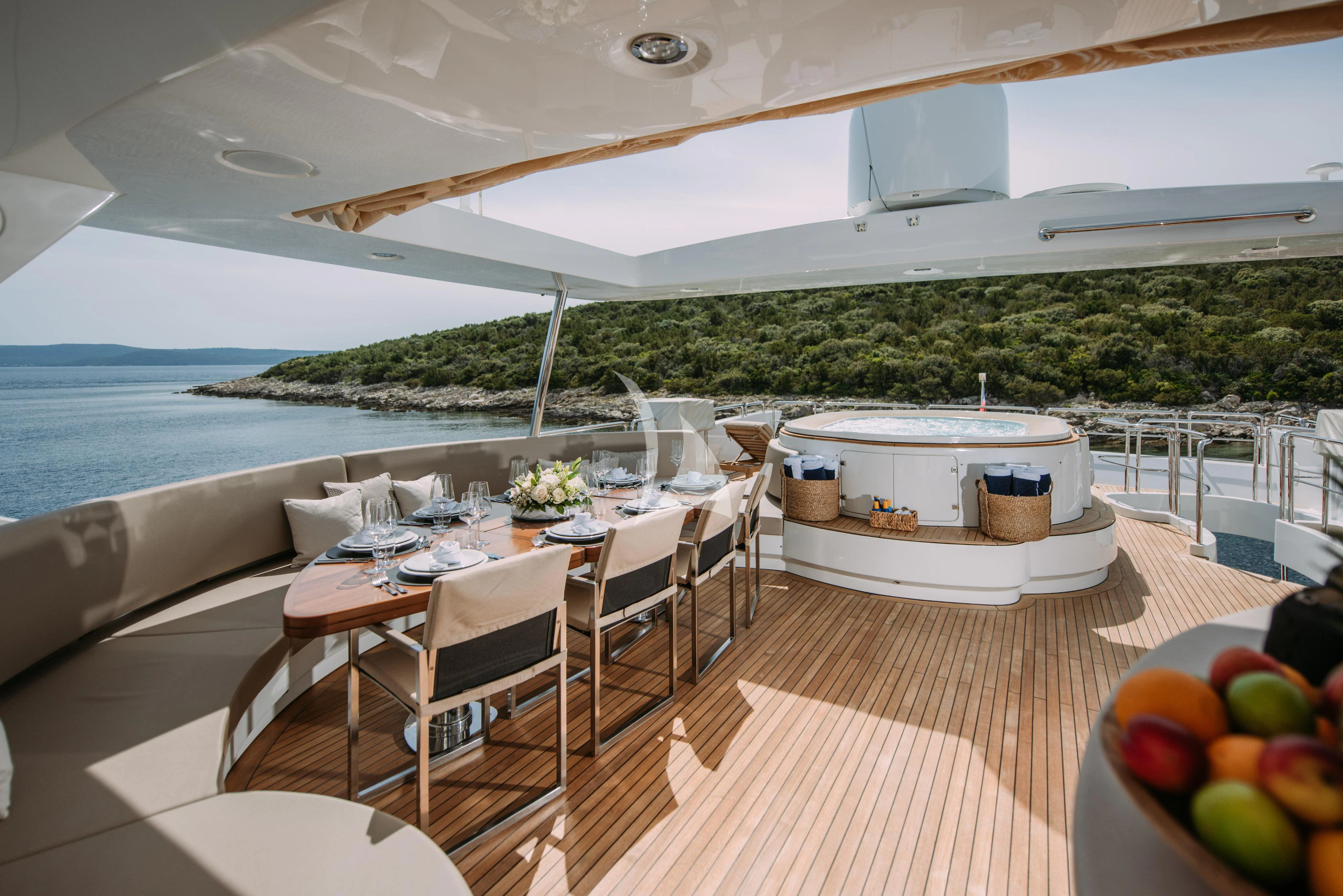 a large white tent with tables and chairs and a large body of water aboard ARTEMY Yacht for Sale