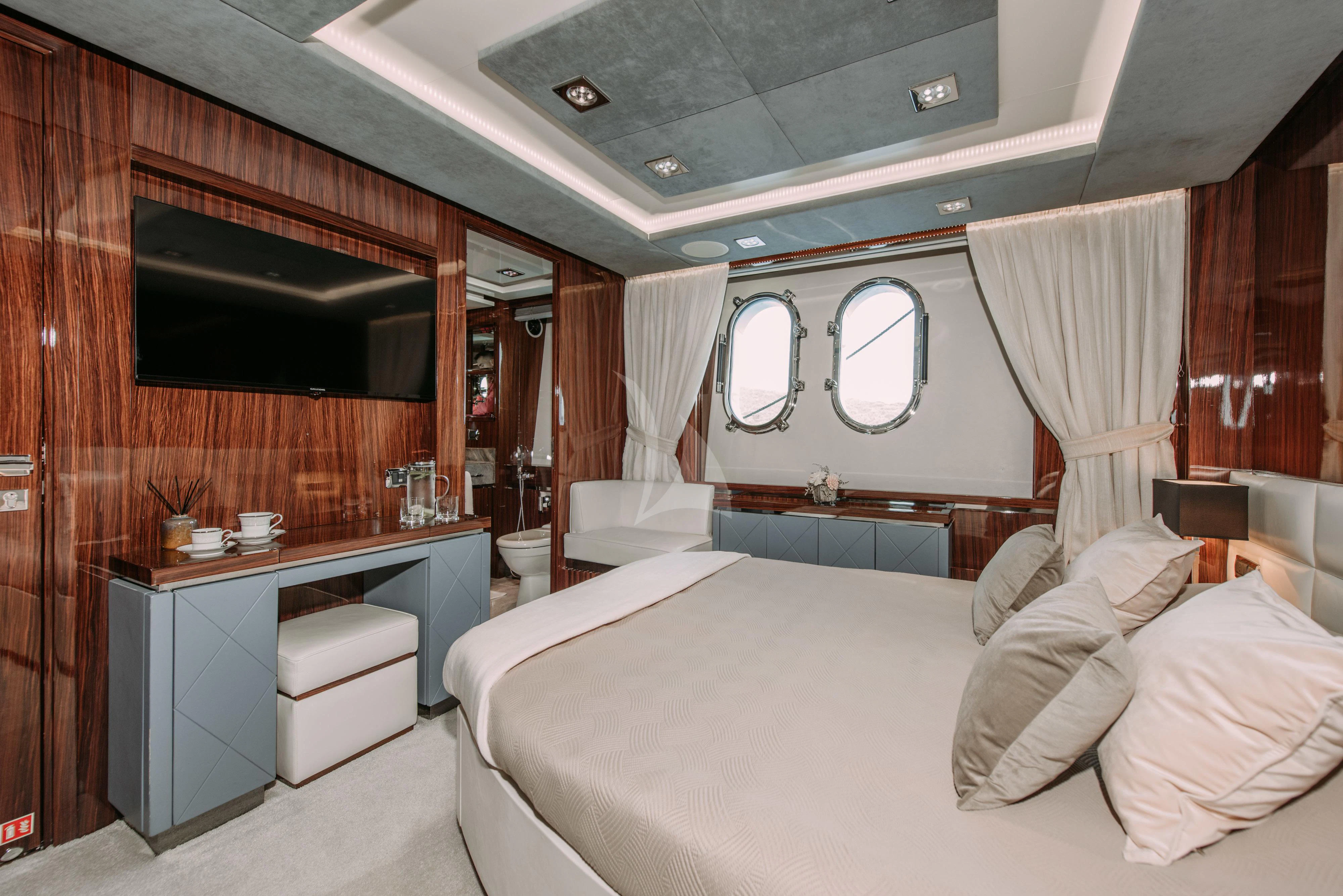 a room with a bed and a desk aboard ARTEMY Yacht for Sale