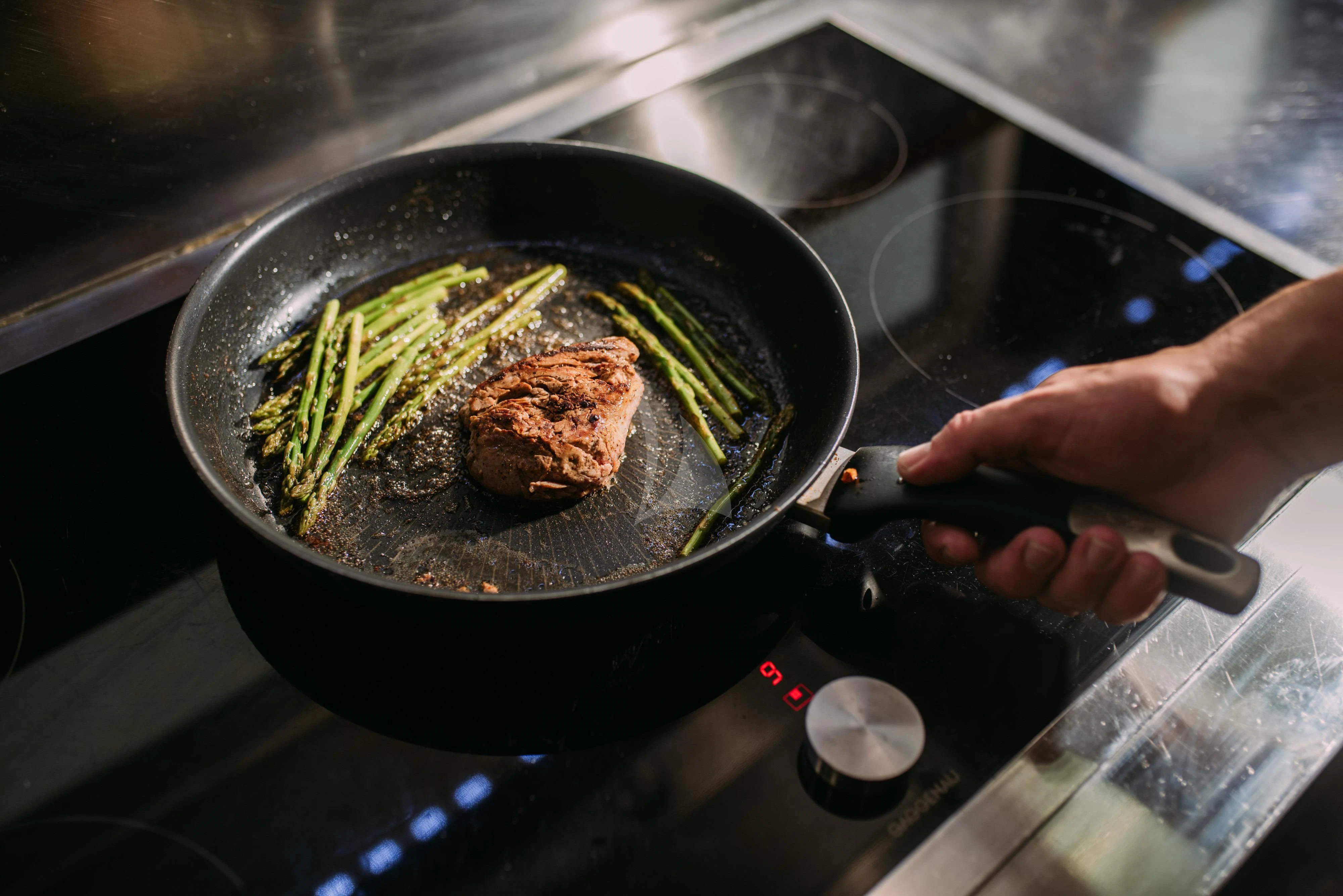 a person cooking food on a stove aboard ARTEMY Yacht for Sale