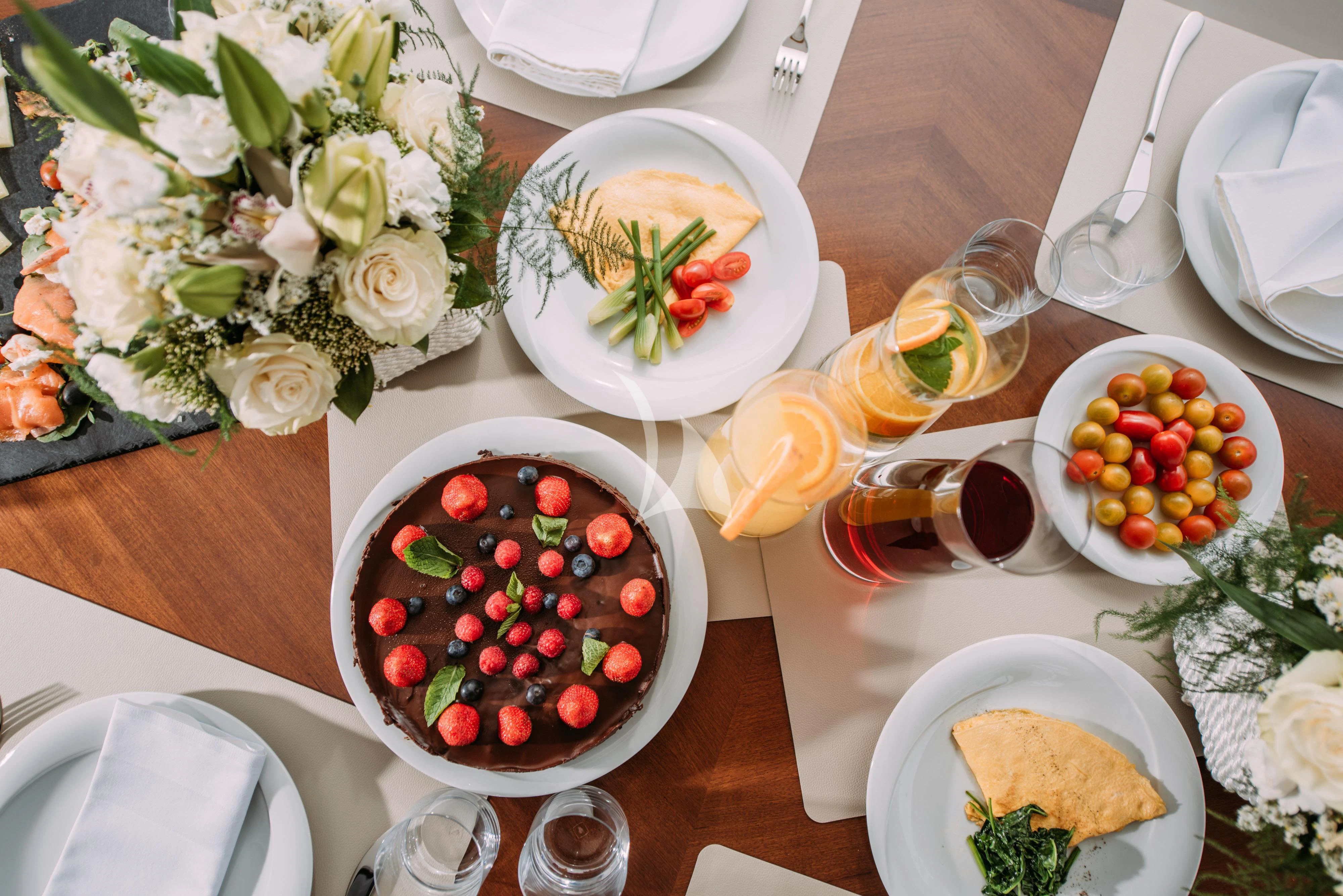a table with plates of food and silverware aboard ARTEMY Yacht for Sale