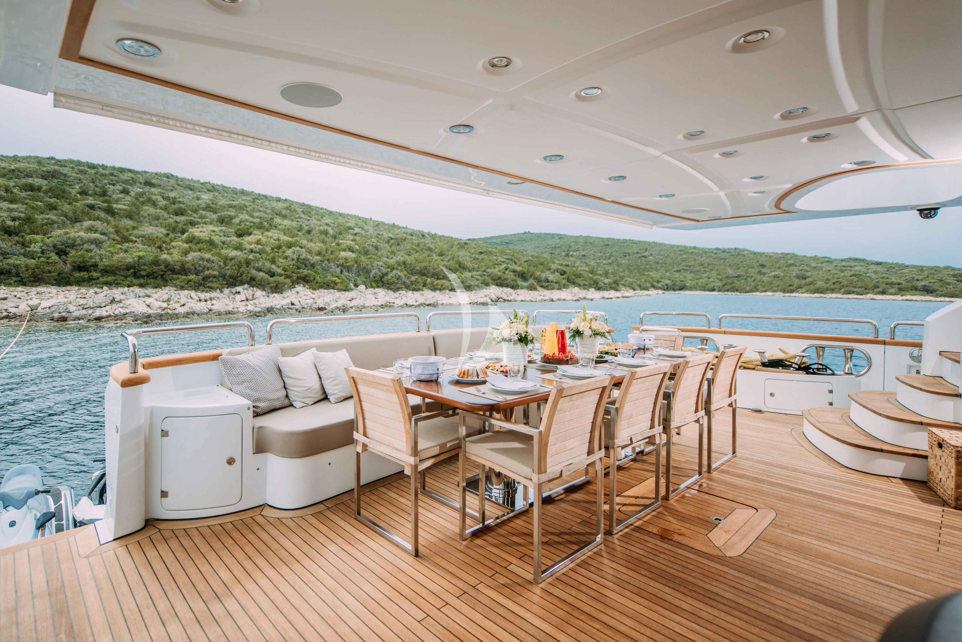 a dining table on a deck aboard ARTEMY Yacht for Sale
