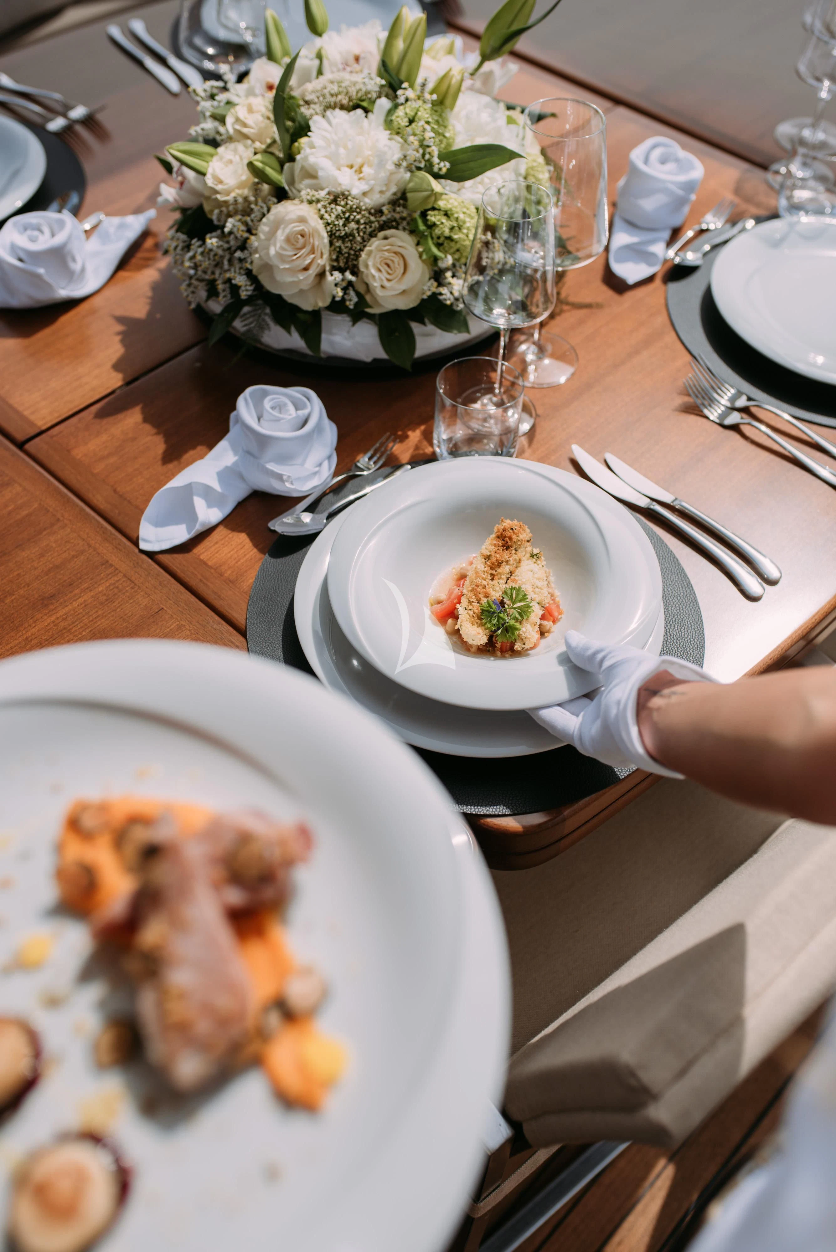a table with plates and silverware aboard ARTEMY Yacht for Sale