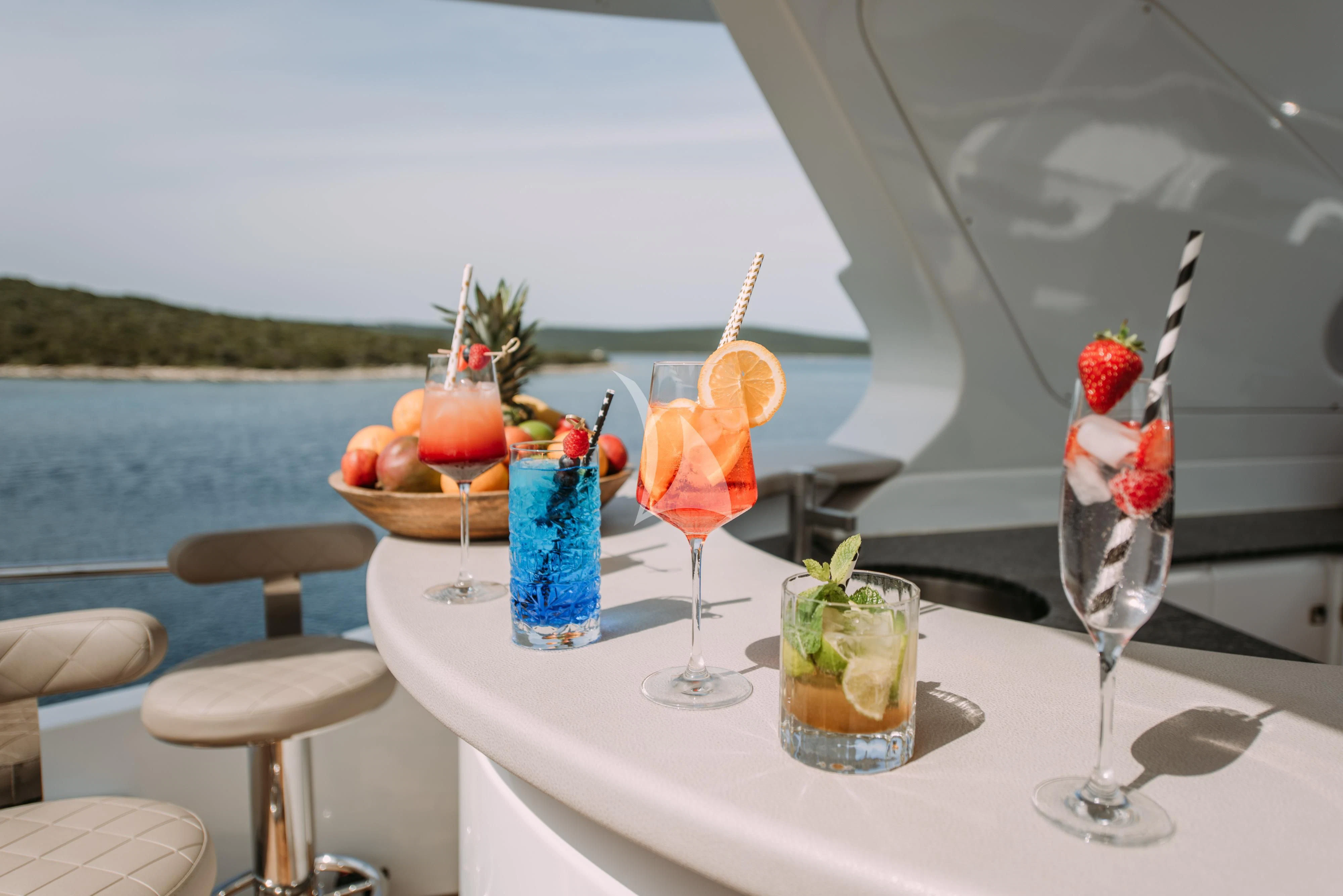a table with drinks and fruits on it aboard ARTEMY Yacht for Sale