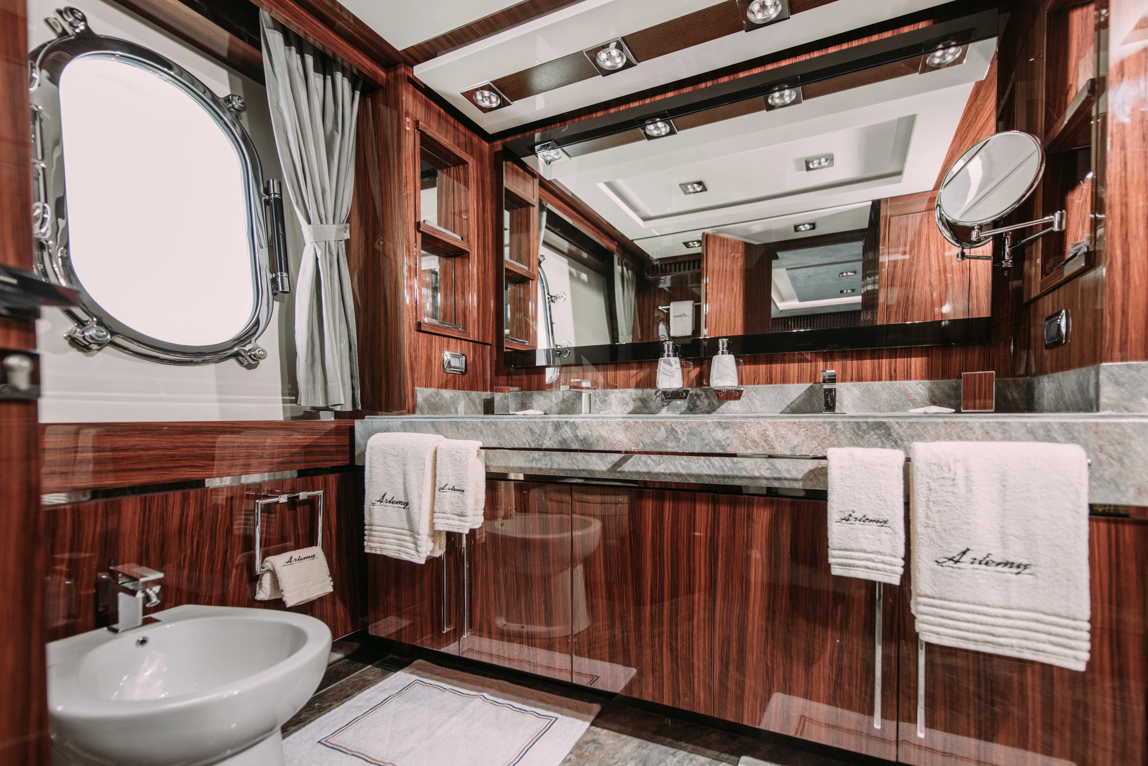 a bathroom with a large mirror aboard ARTEMY Yacht for Sale
