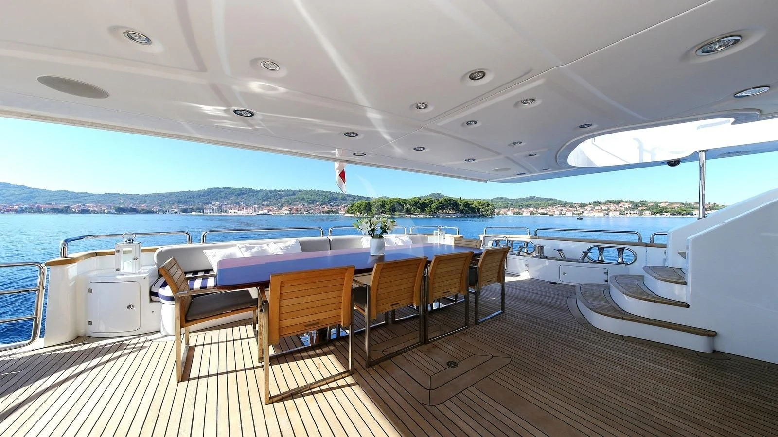 a deck with a table and chairs aboard ARTEMY Yacht for Sale