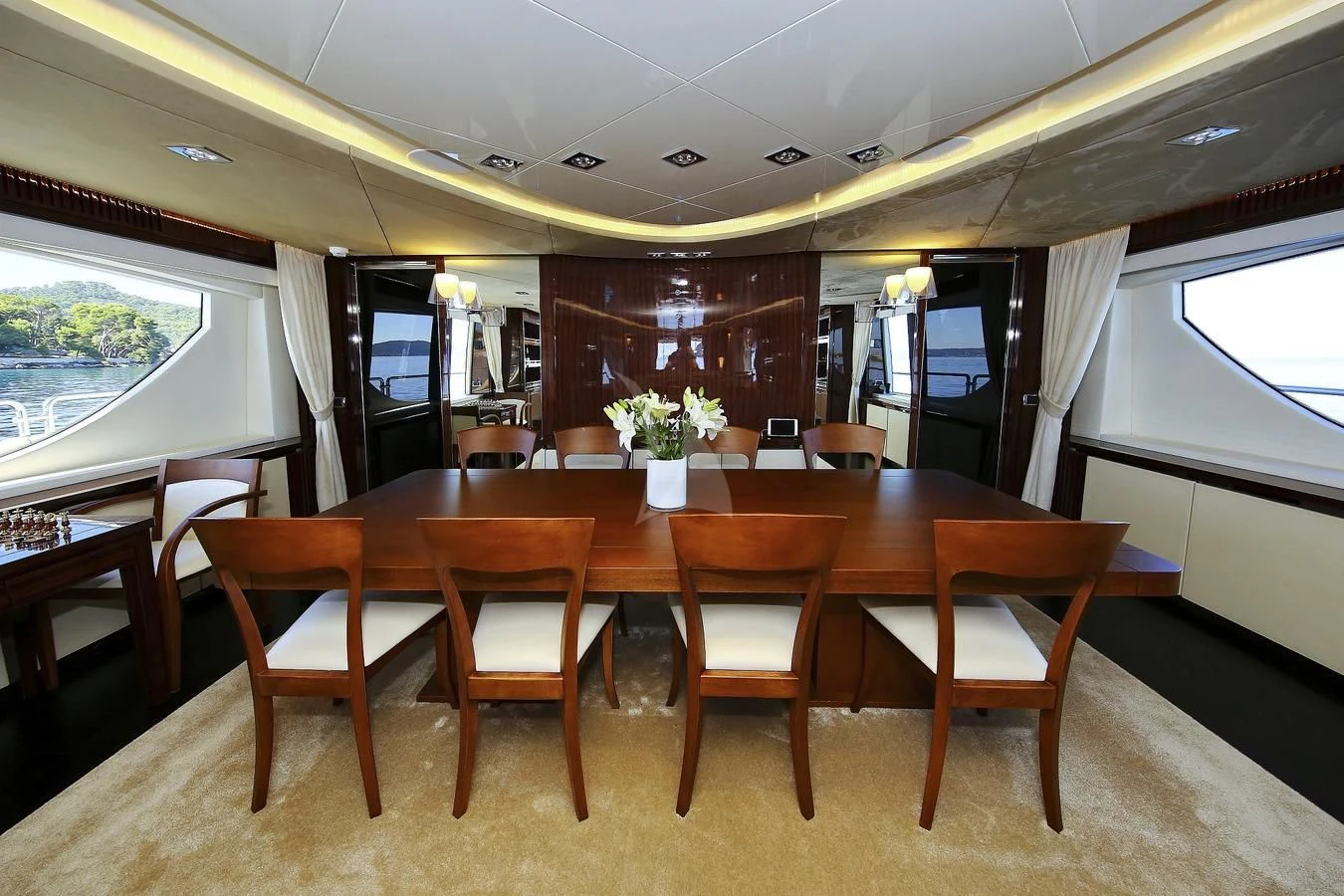 a large wooden table with chairs around it aboard ARTEMY Yacht for Sale