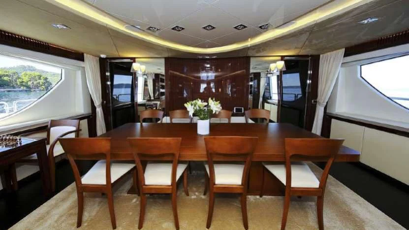 a table with chairs and a bench aboard ARTEMY Yacht for Sale