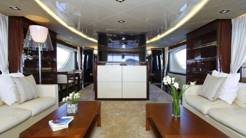 a living room with a table and couches aboard ARTEMY Yacht for Sale