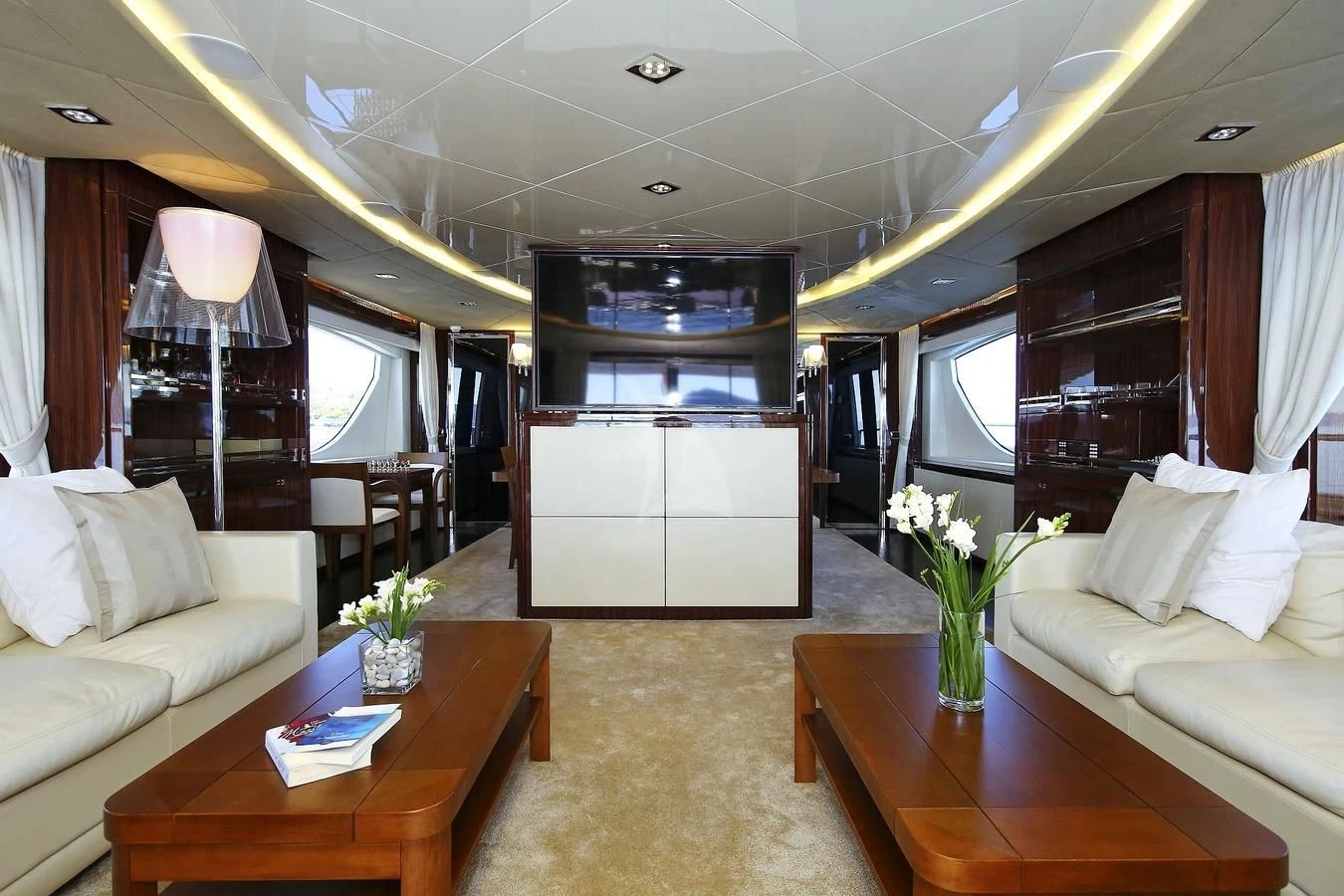 a living room with a table and couches aboard ARTEMY Yacht for Sale