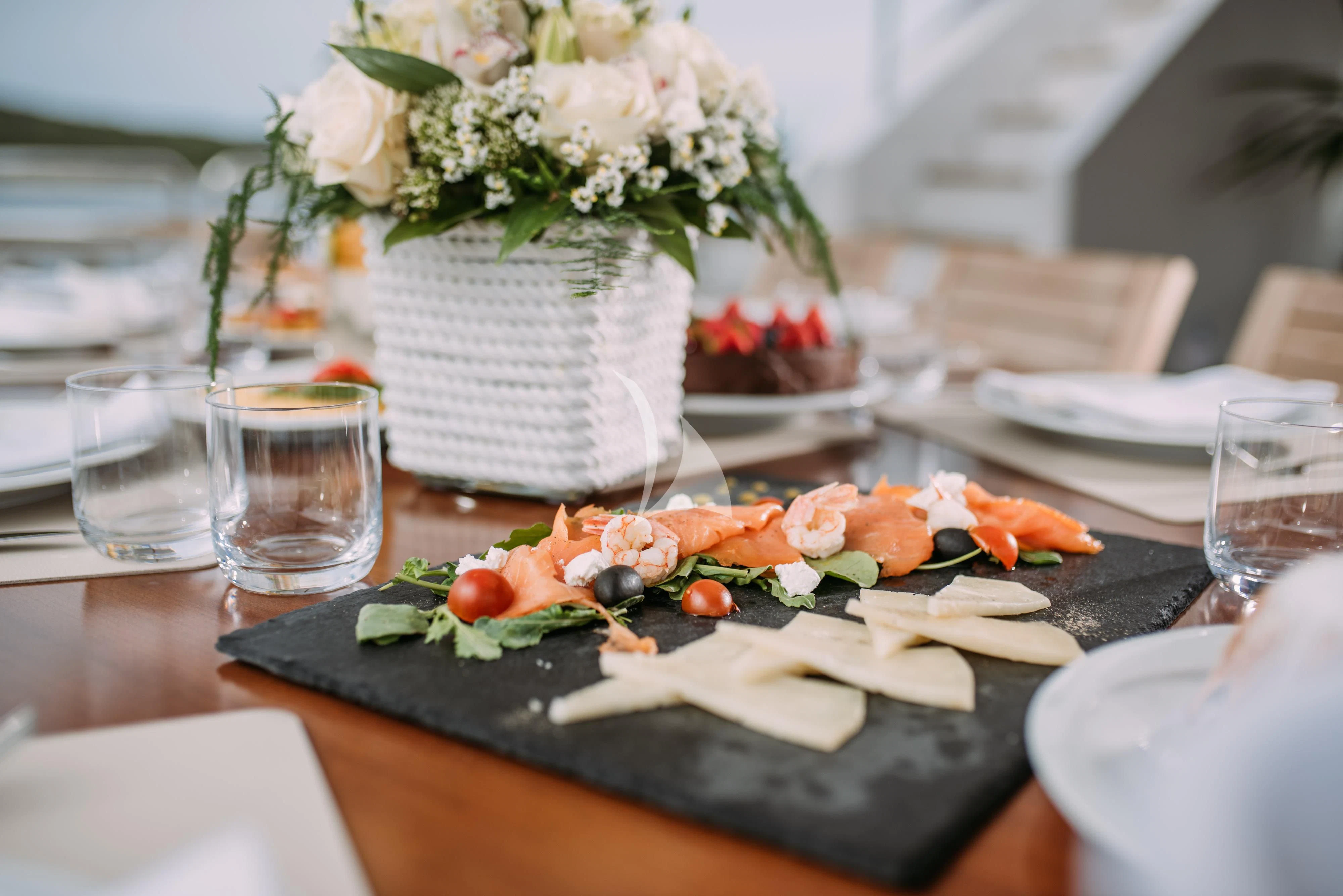 a table with plates and glasses aboard ARTEMY Yacht for Sale