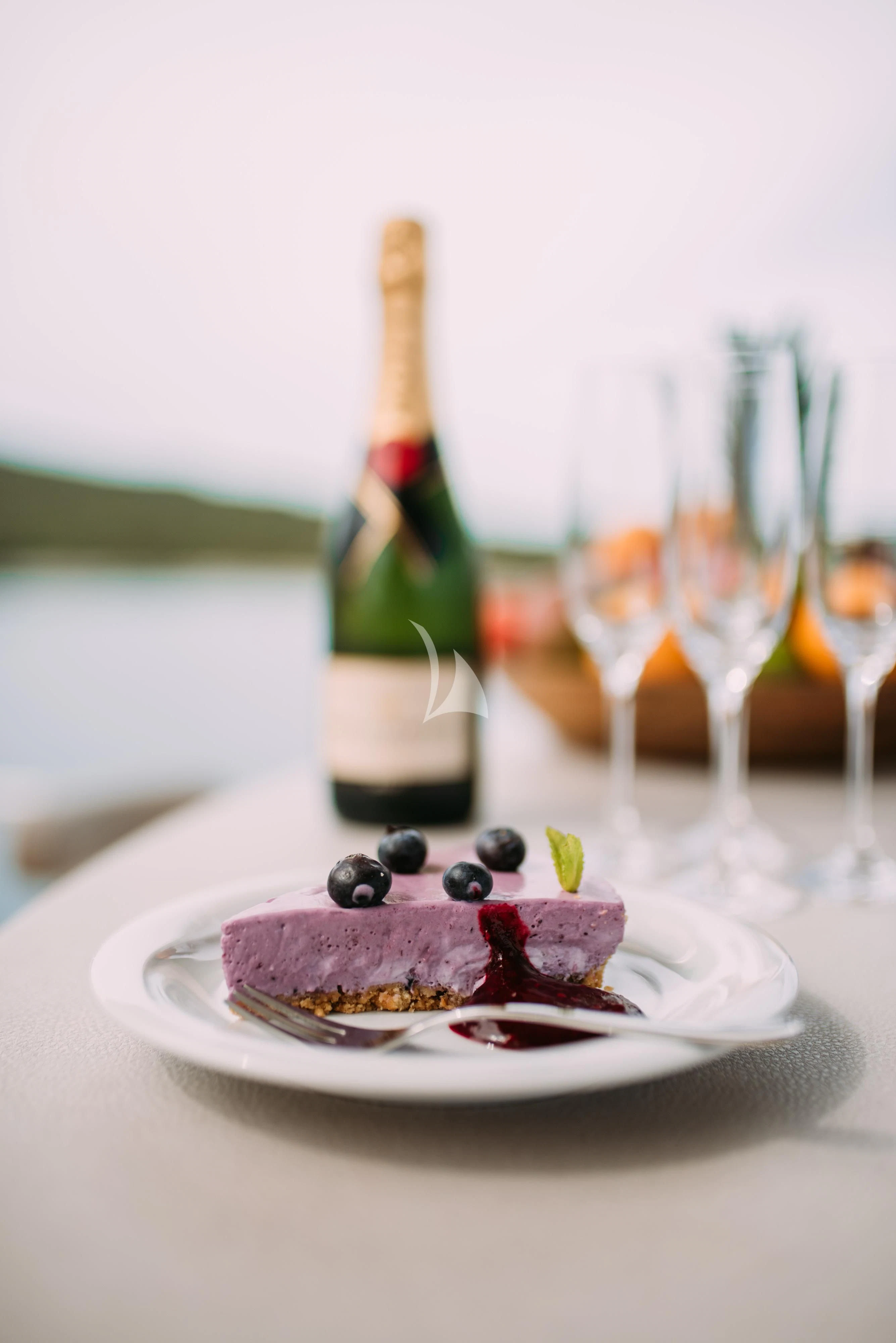 a plate of food and wine aboard ARTEMY Yacht for Sale