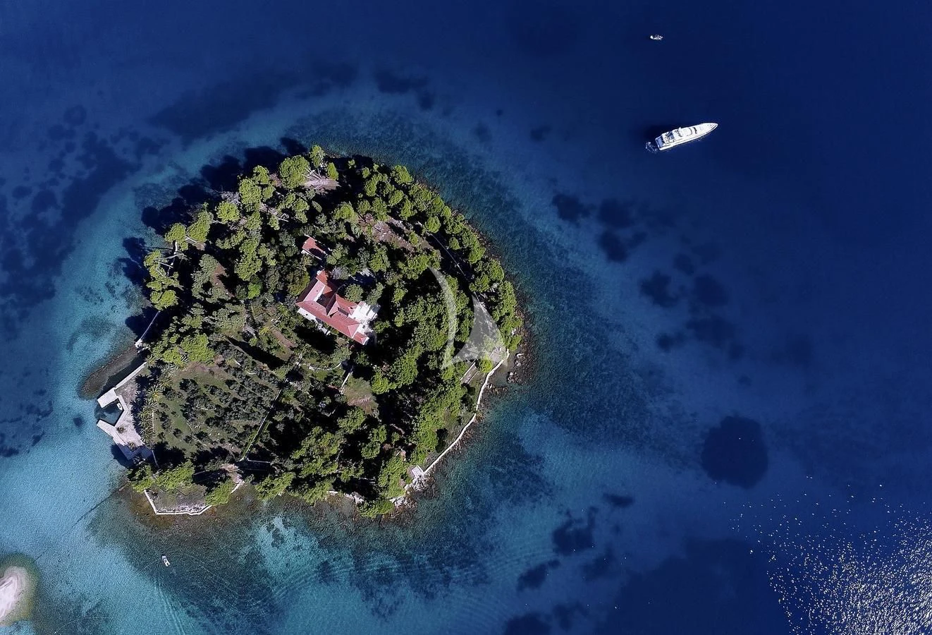 an island with buildings and a boat aboard ARTEMY Yacht for Sale