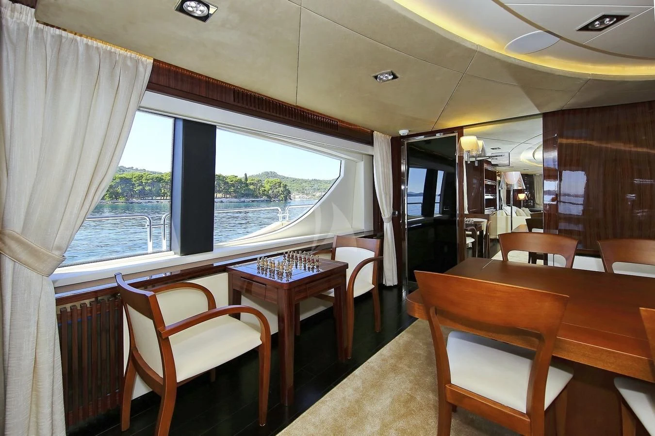 a room with a table and chairs aboard ARTEMY Yacht for Sale