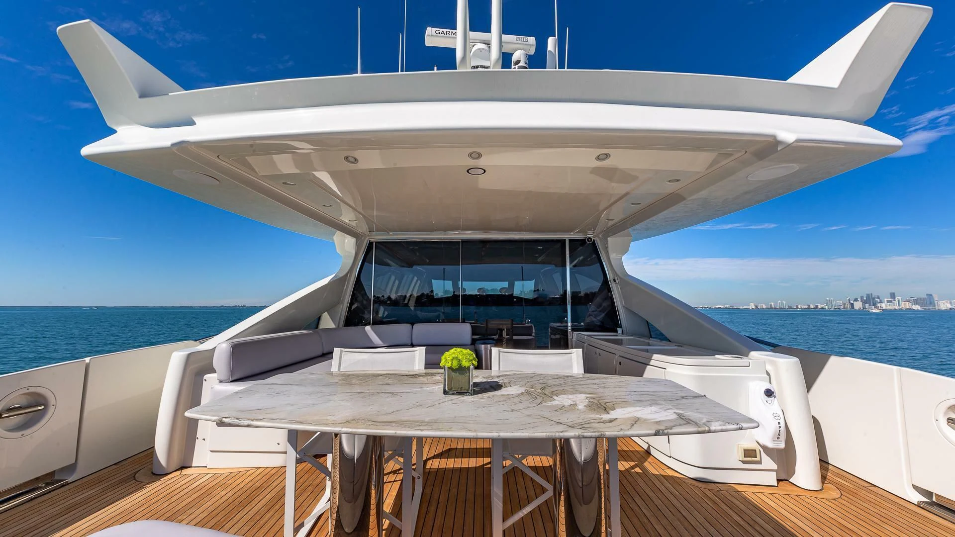 a white boat on a deck aboard M Yacht for Charter