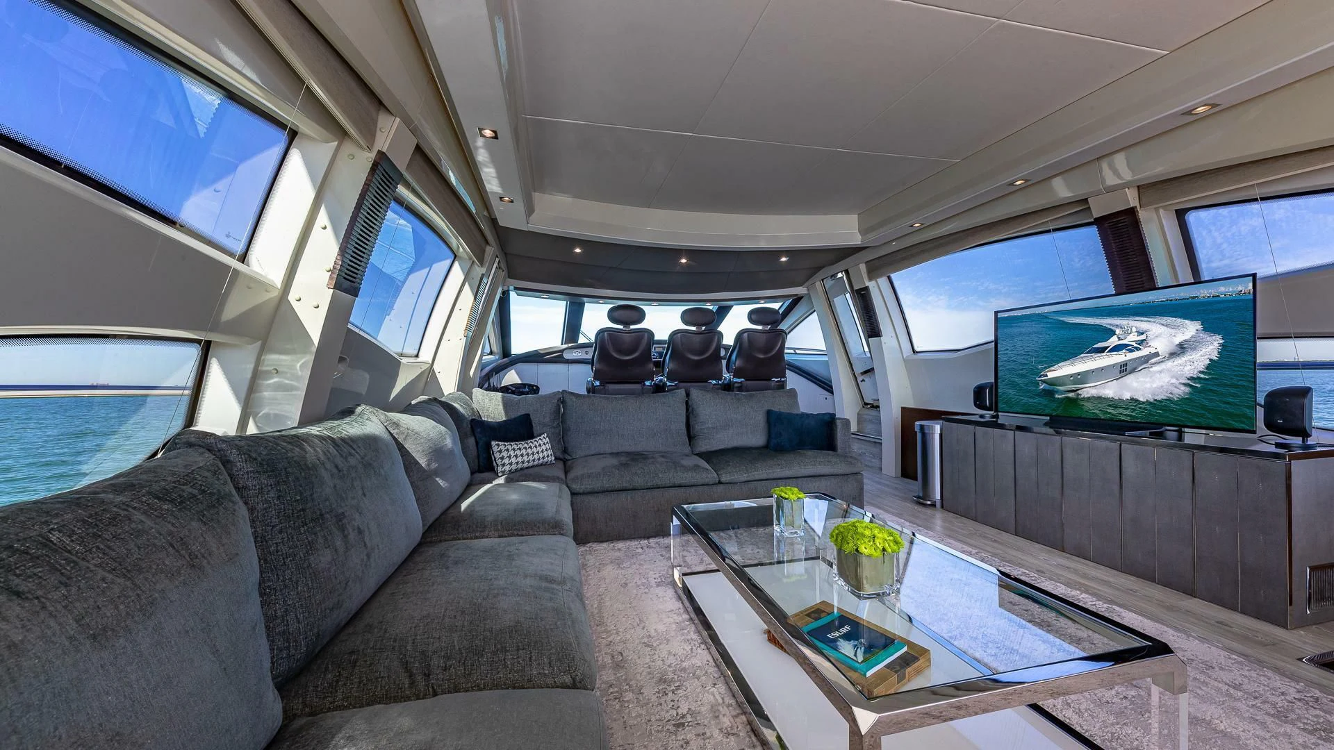 a car with a table and a tv on the wall aboard M Yacht for Charter