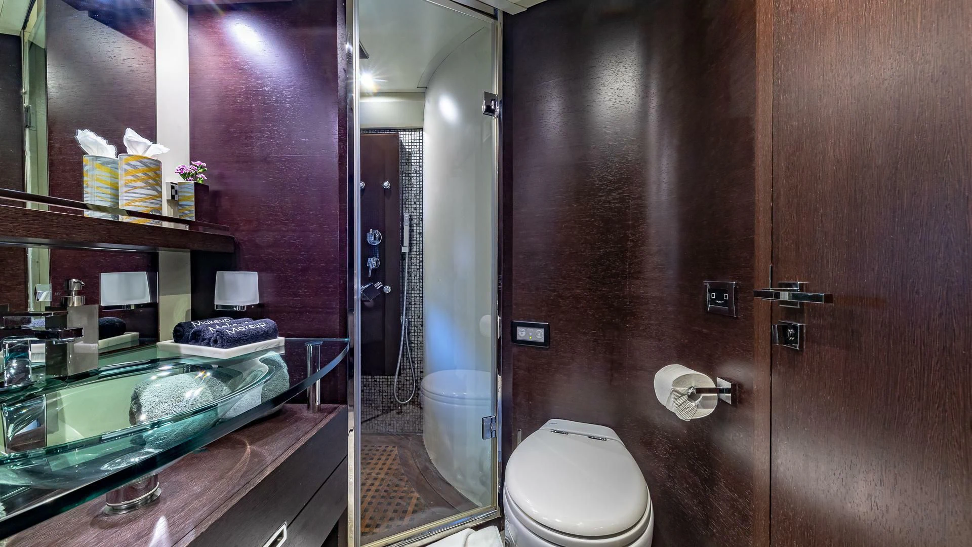 a bathroom with a glass shower aboard M Yacht for Charter