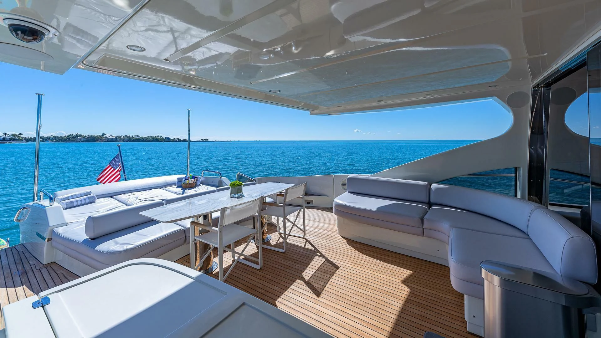 a boat with a table and chairs on the deck aboard M Yacht for Charter