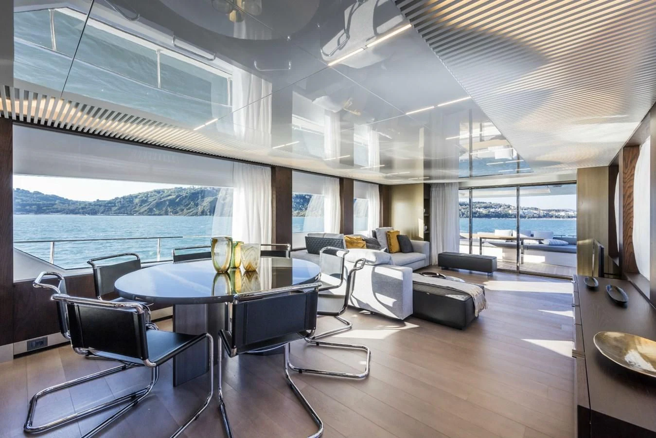 a room with a table chairs and a large window aboard FERRETTI YACHTS 850 Yacht for Sale