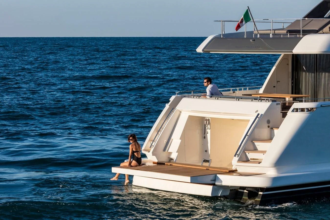 a man and woman sitting on a boat in the water aboard FERRETTI YACHTS 850 Yacht for Sale