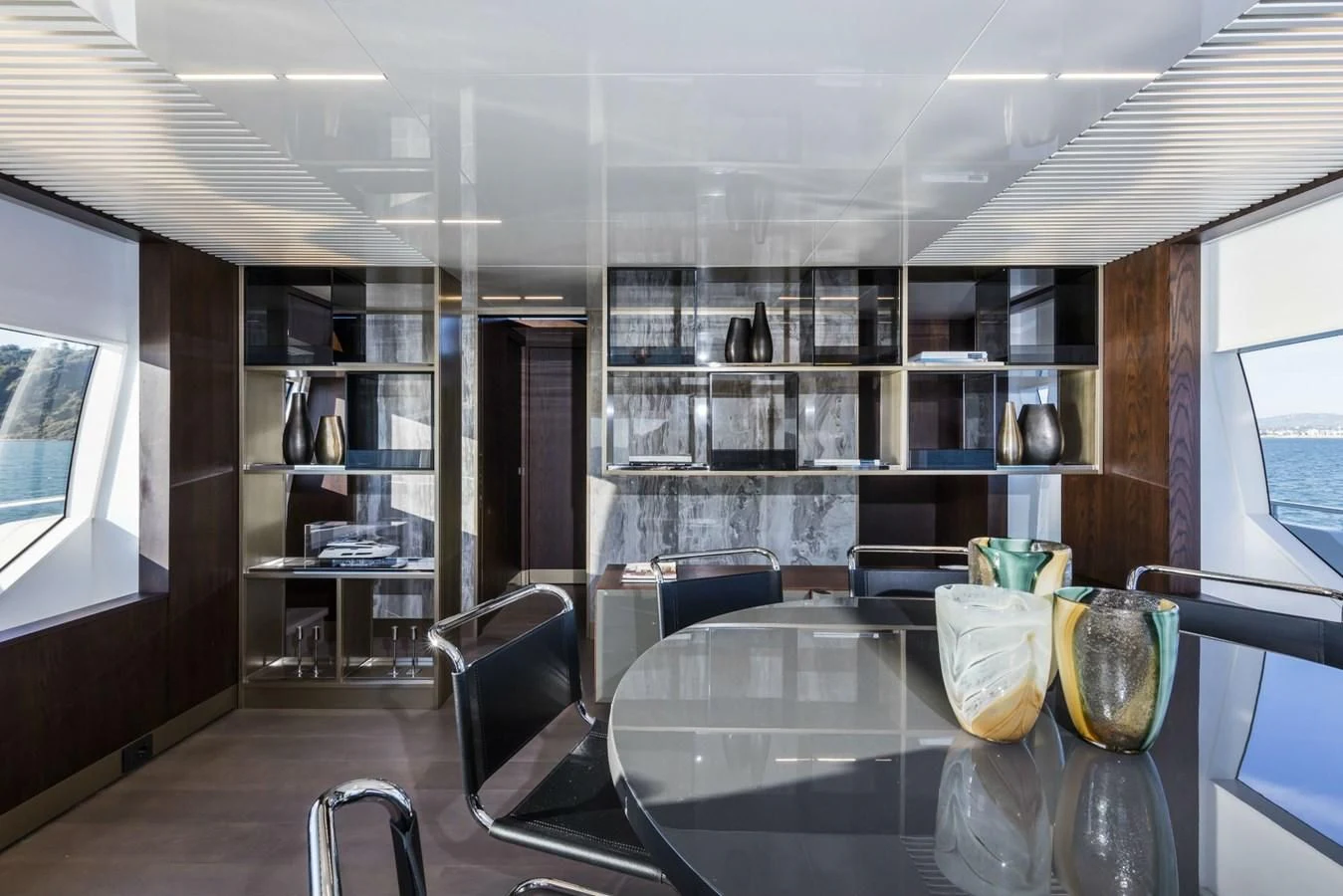 a room with a table and chairs aboard FERRETTI YACHTS 850 Yacht for Sale