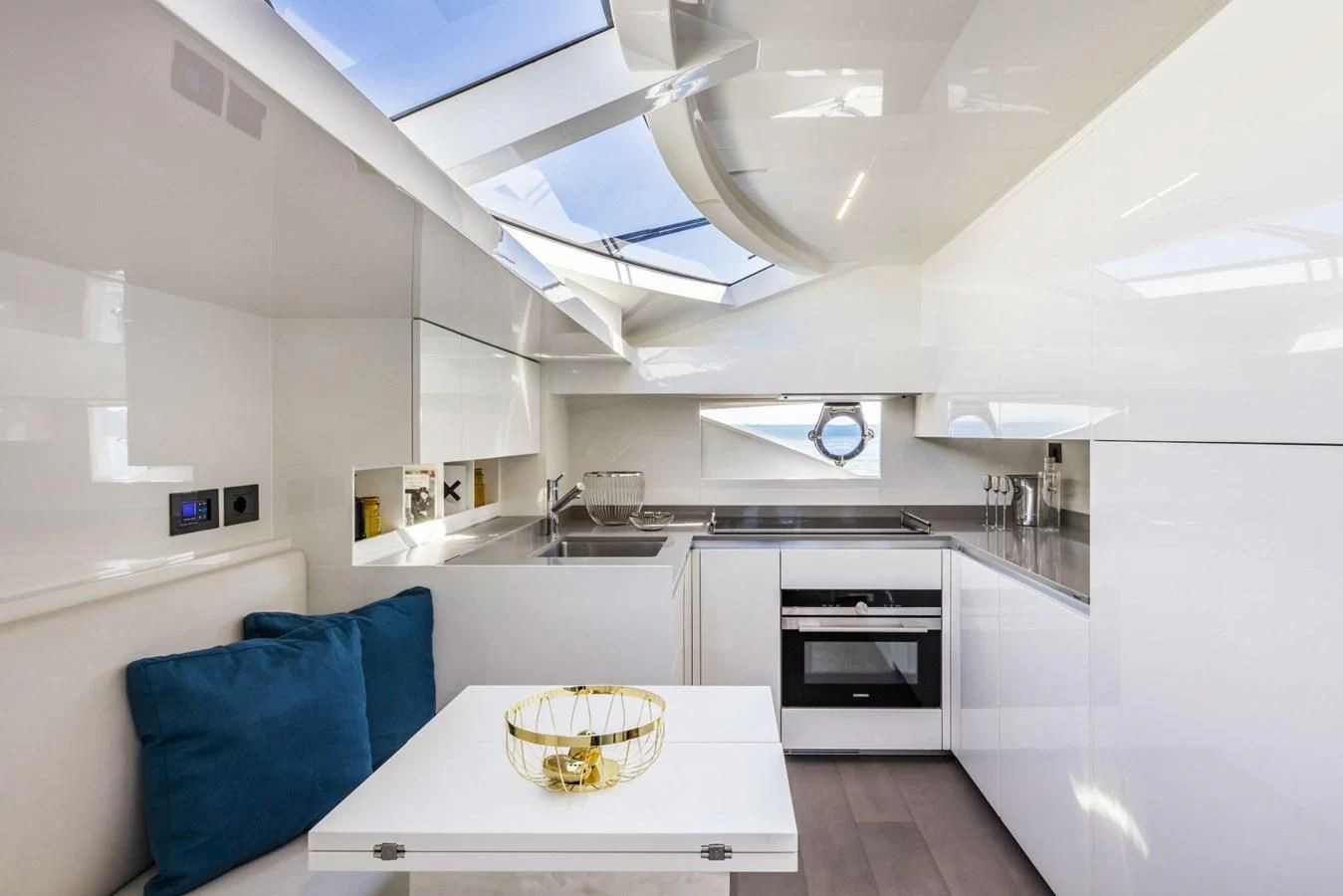 a kitchen with a table and a couch aboard FERRETTI YACHTS 850 Yacht for Sale