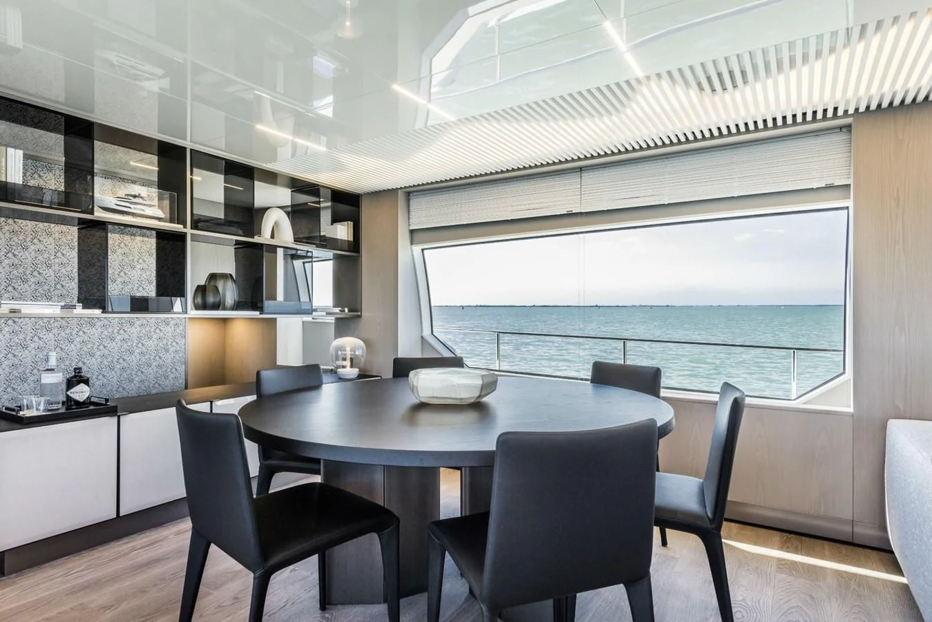 a kitchen with a table and chairs aboard FERRETTI YACHTS 850 Yacht for Sale