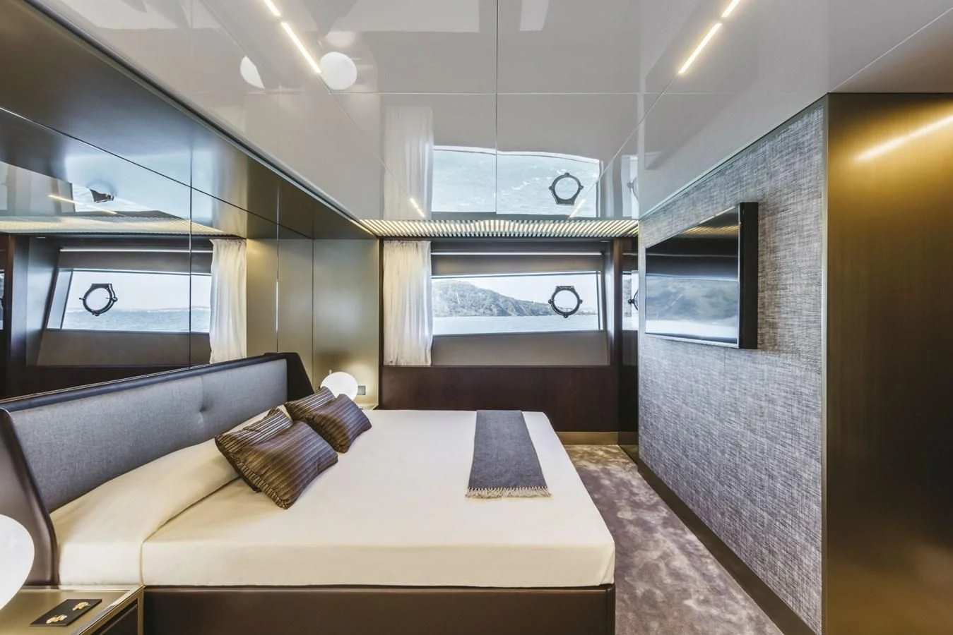 a room with a bed and a wall of windows aboard FERRETTI YACHTS 850 Yacht for Sale