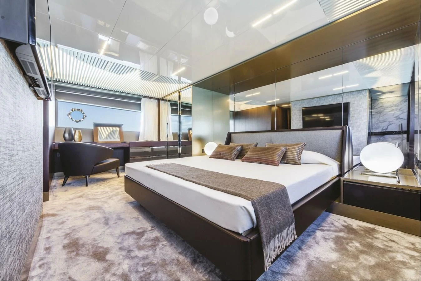 a bedroom with a bed and a chair aboard FERRETTI YACHTS 850 Yacht for Sale