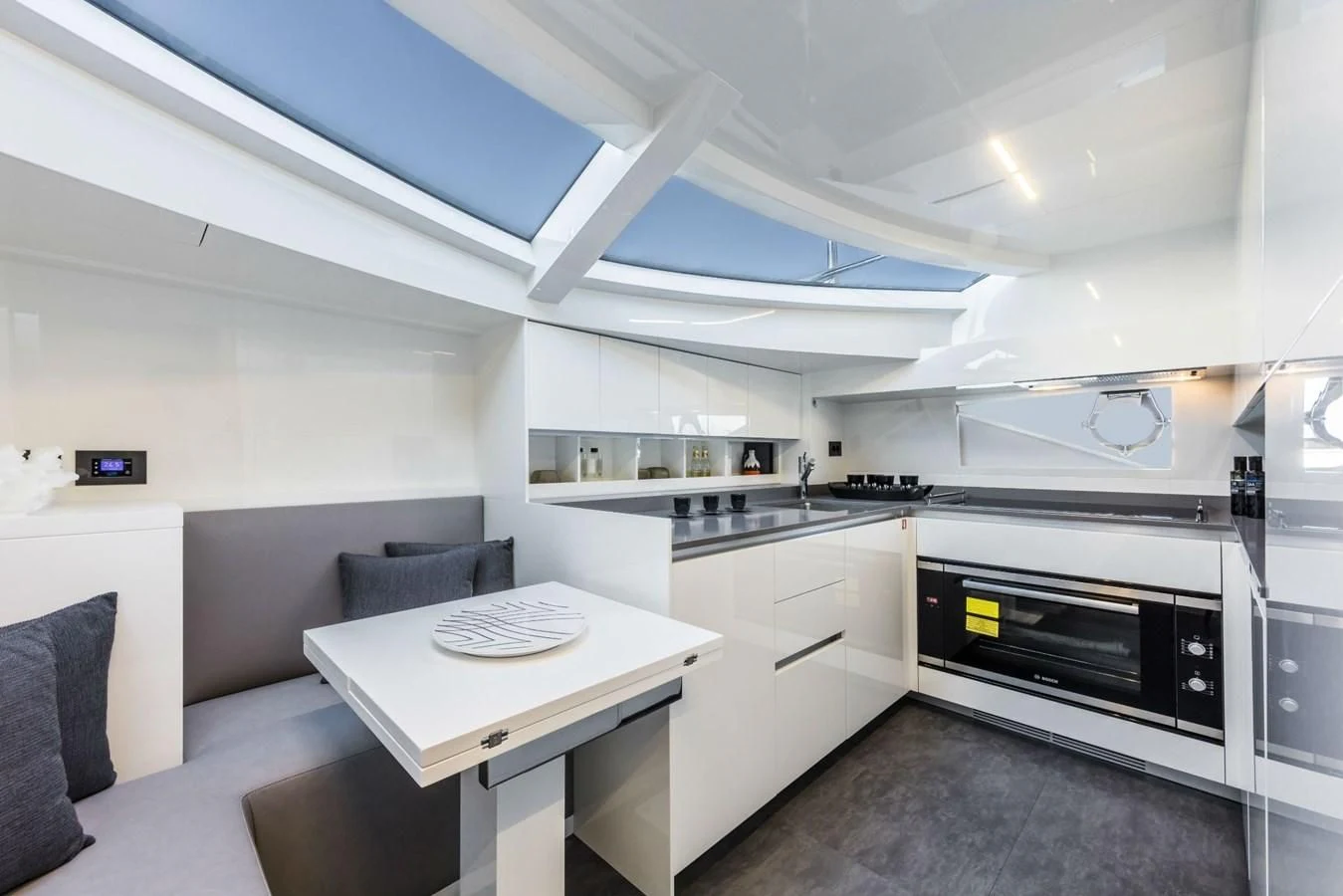 a kitchen with a table and chairs aboard FERRETTI YACHTS 850 Yacht for Sale