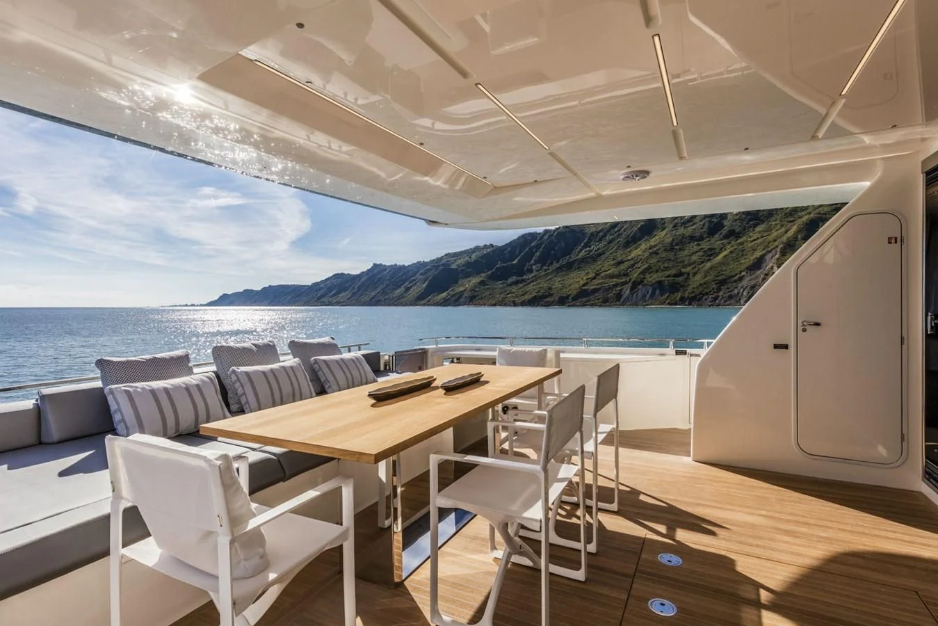 a room with a table and chairs aboard FERRETTI YACHTS 850 Yacht for Sale