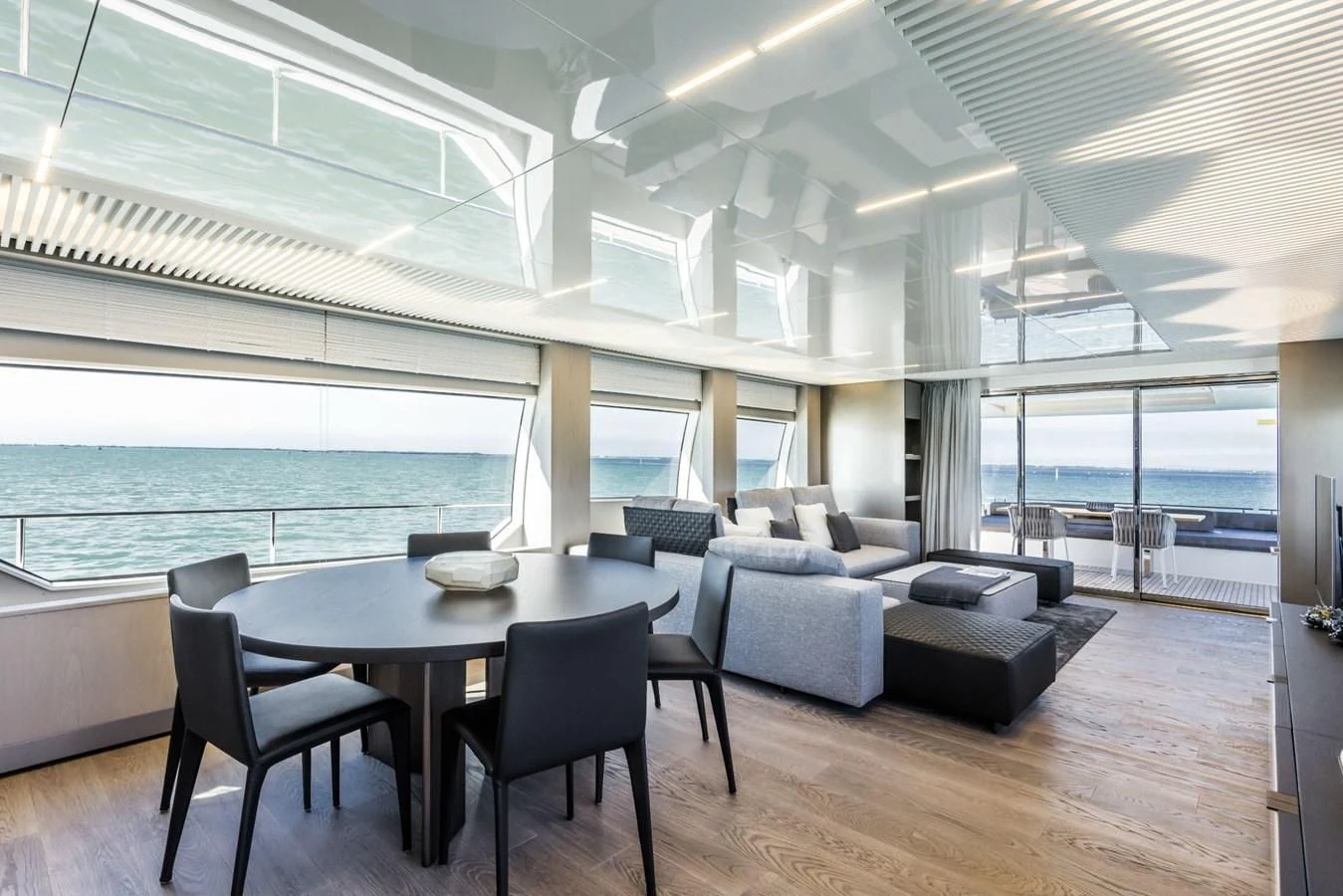 a large room with a table and chairs aboard FERRETTI YACHTS 850 Yacht for Sale