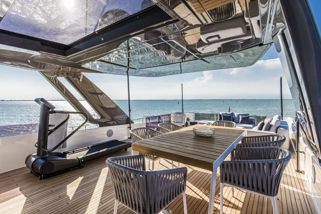 a deck with a table and chairs on it aboard FERRETTI YACHTS 850 Yacht for Sale