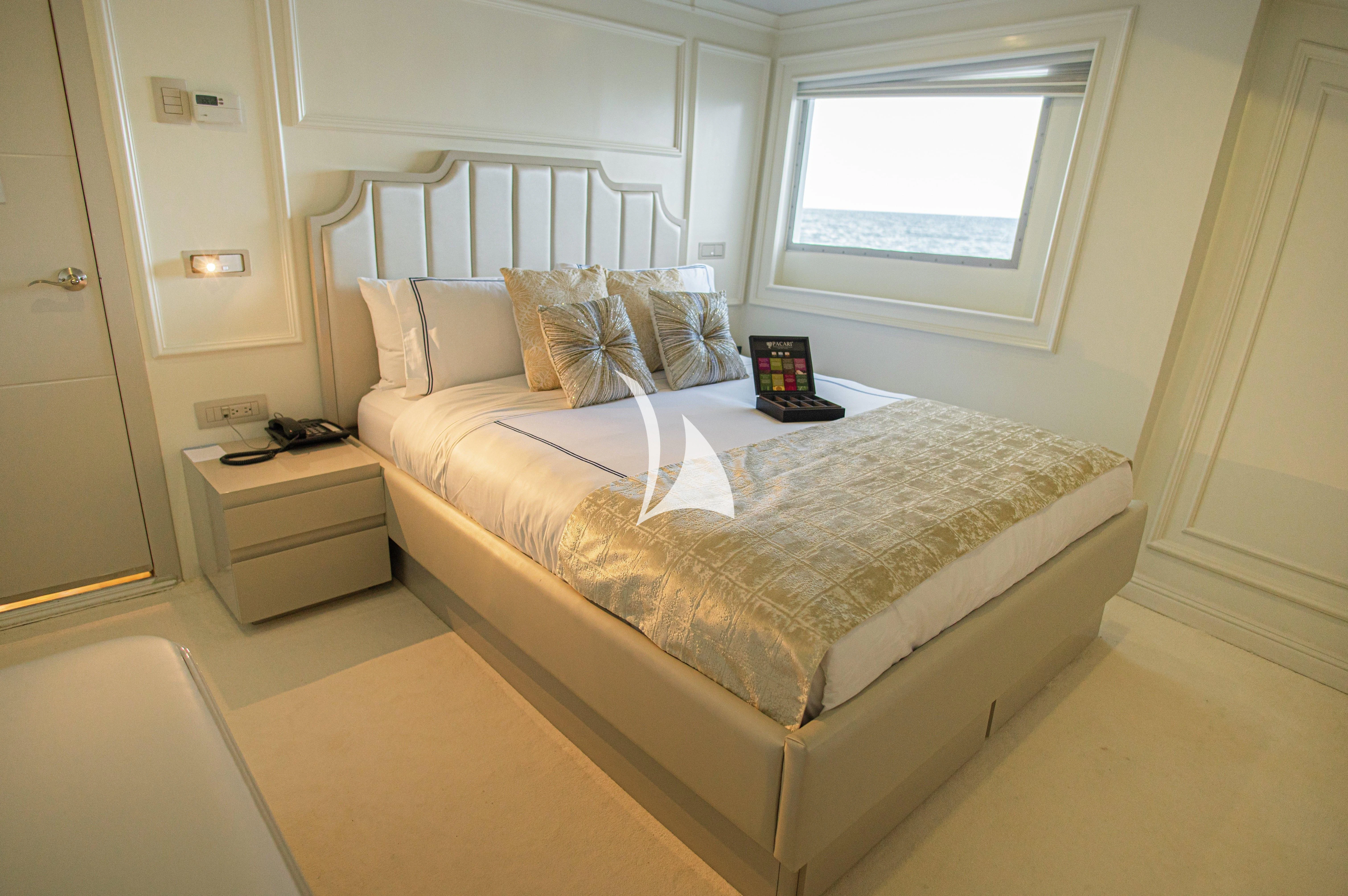 a bed with a laptop on it aboard GALAPAGOS EXPLORER Yacht for Sale