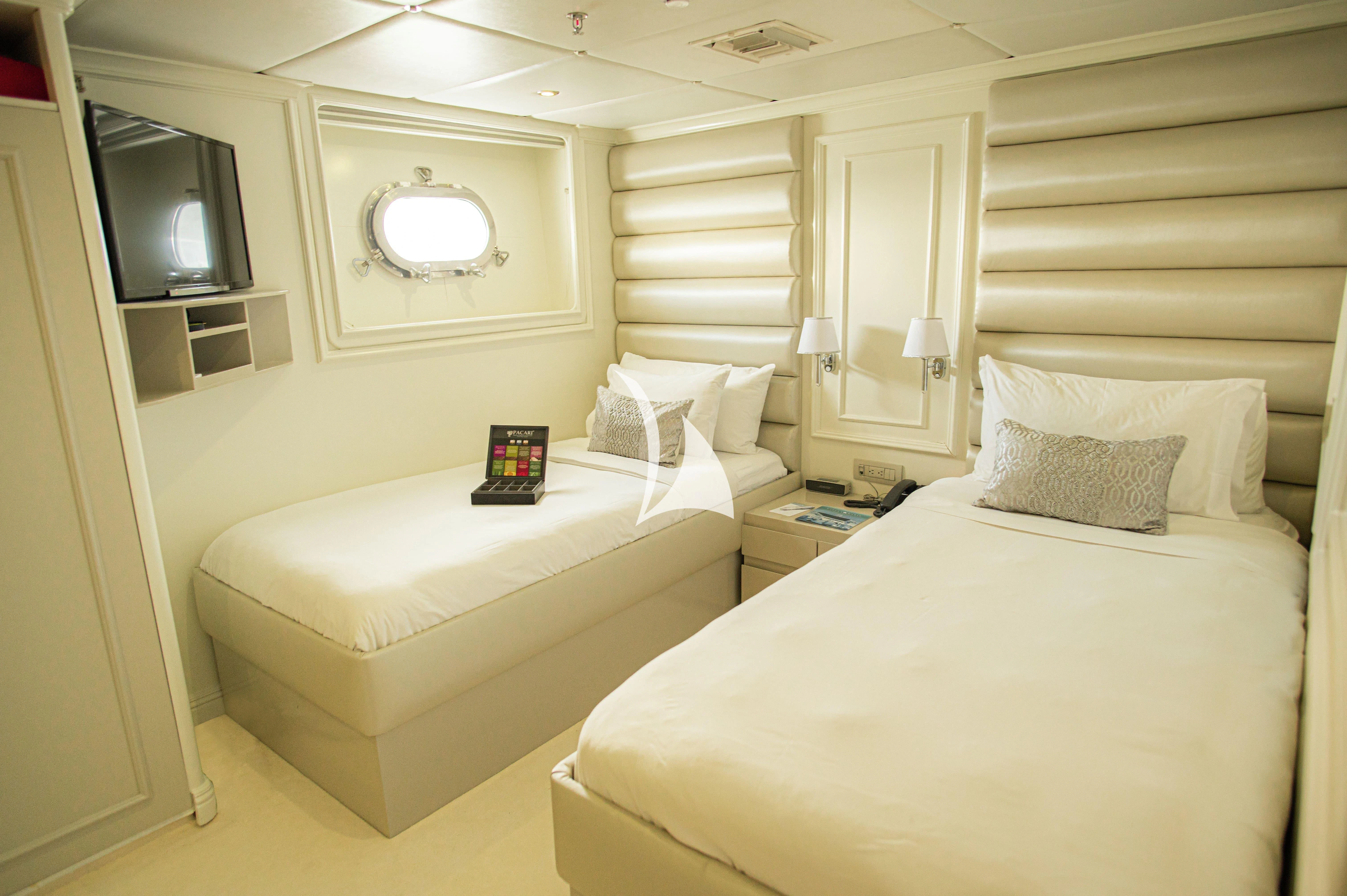 a room with two beds aboard GALAPAGOS EXPLORER Yacht for Sale