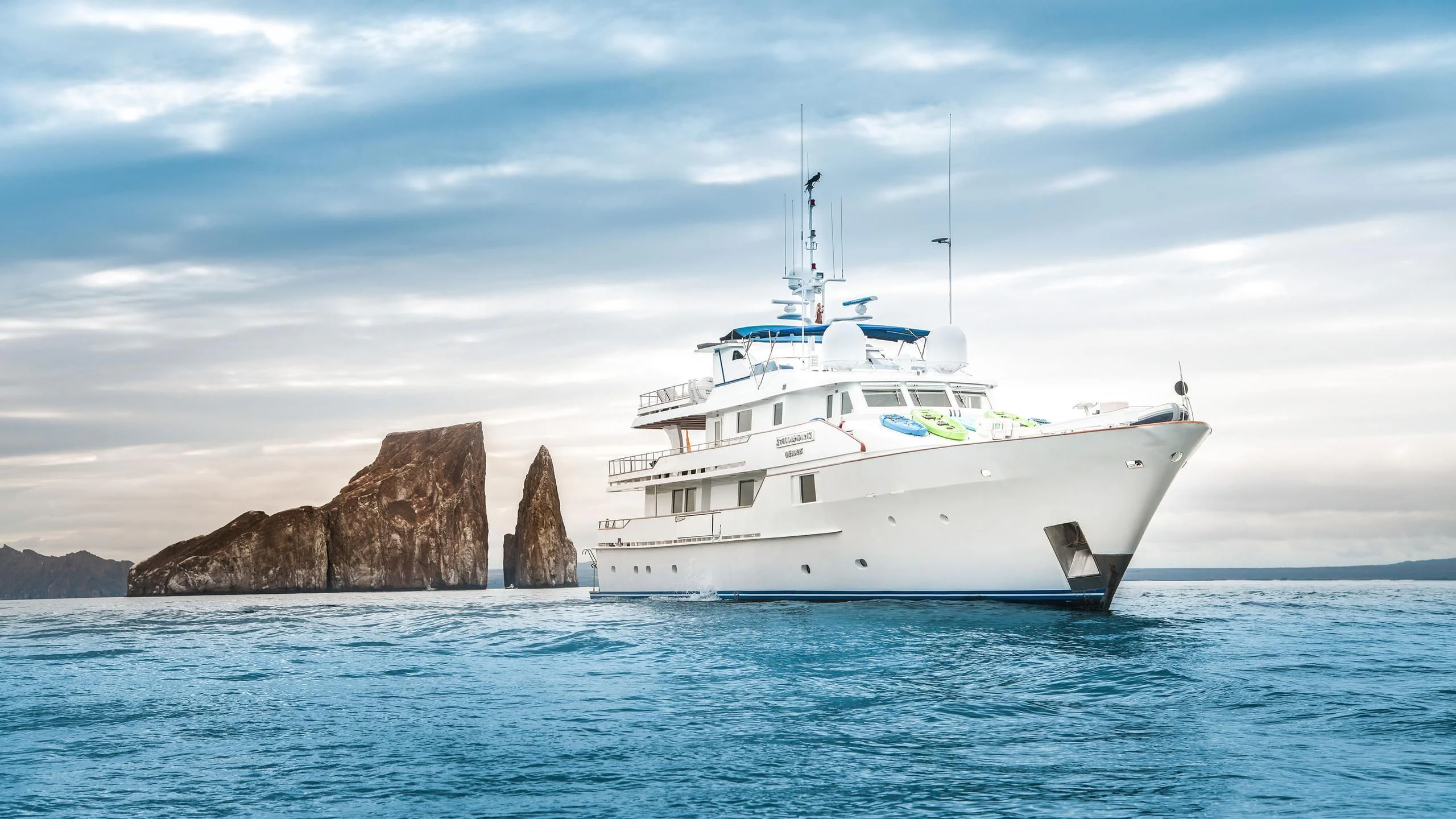 a white boat in the water aboard GALAPAGOS EXPLORER Yacht for Sale