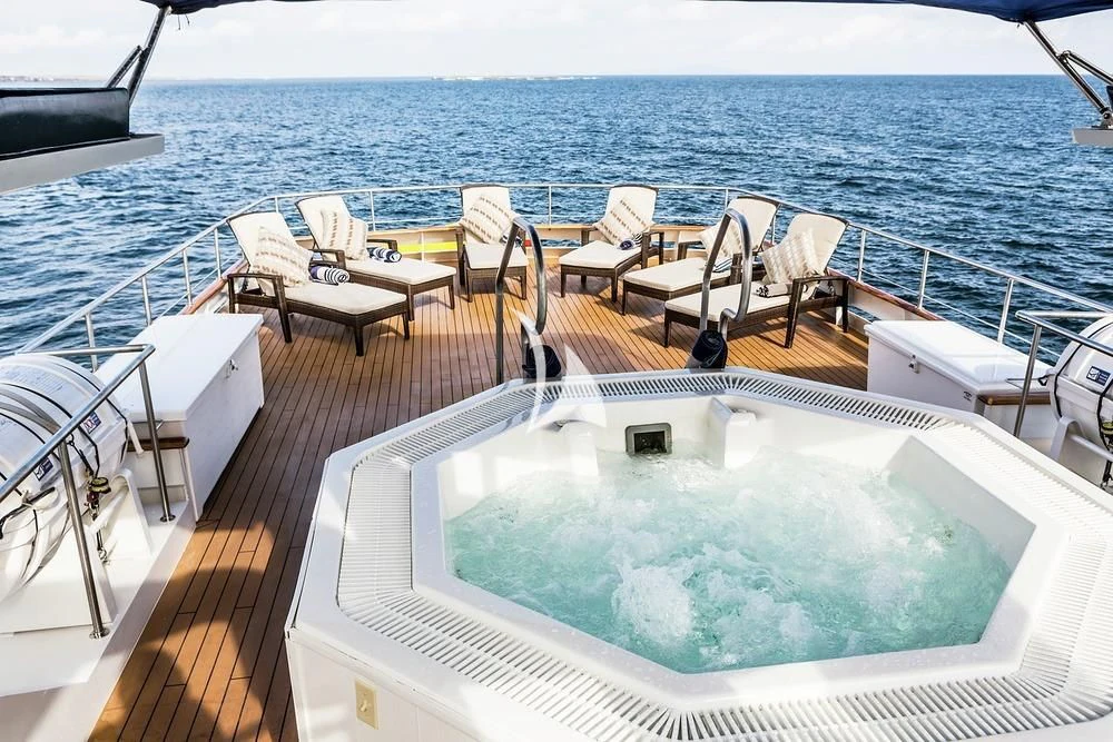 a large swimming pool on a deck aboard GALAPAGOS EXPLORER Yacht for Sale