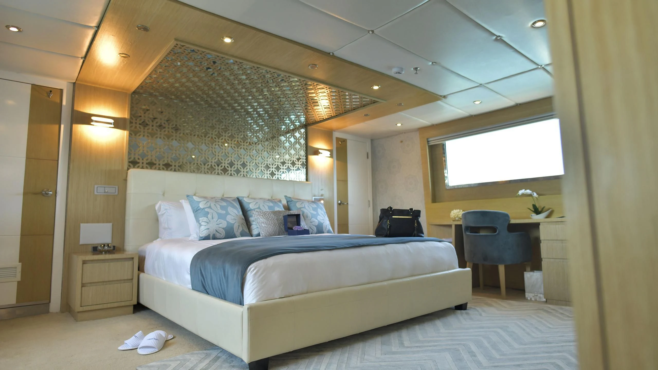 a room with a bed and a desk aboard GALAPAGOS EXPLORER Yacht for Sale