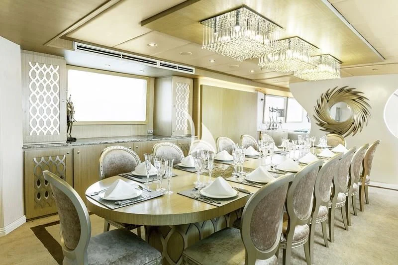 a dining room with a chandelier aboard GALAPAGOS EXPLORER Yacht for Sale