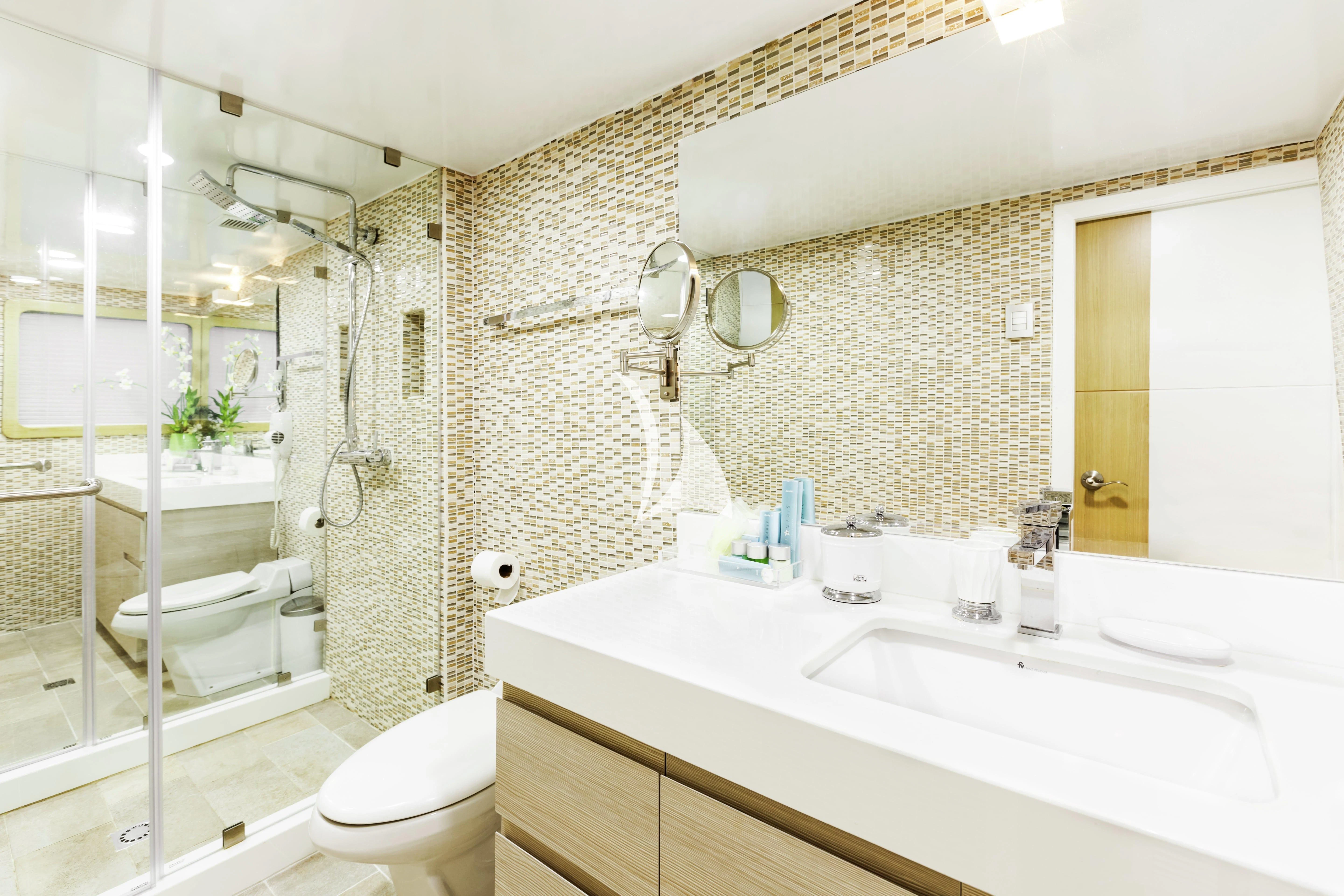 a bathroom with a tub sink and toilet aboard GALAPAGOS EXPLORER Yacht for Sale