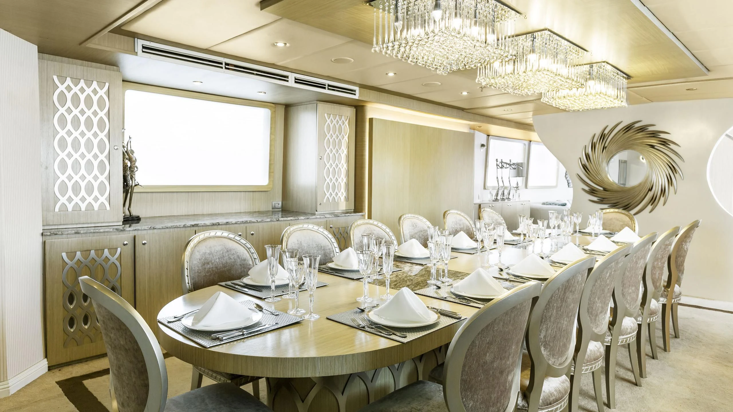 a dining room with a chandelier aboard GALAPAGOS EXPLORER Yacht for Sale